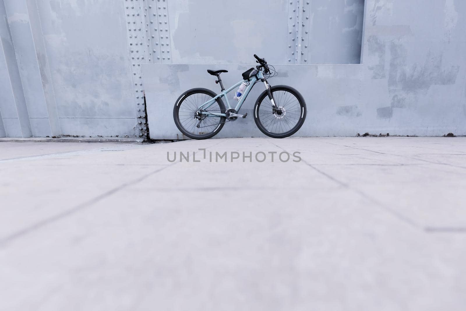 Parked bike The wall is made of gray iron.