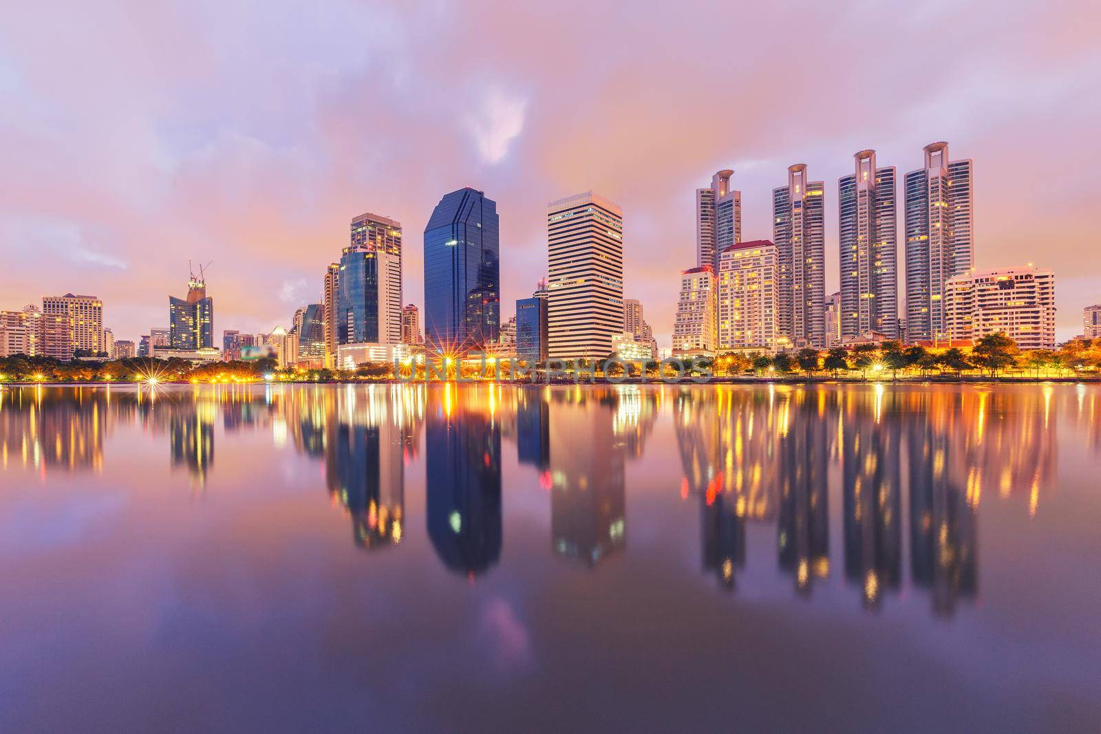 City building with water reflection in twilight