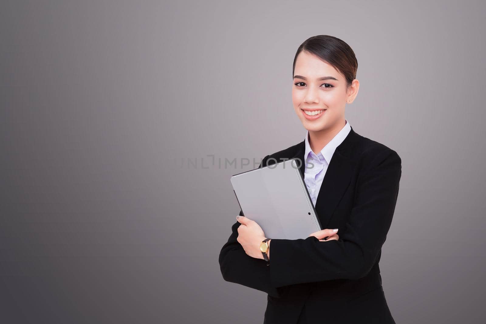 Portrait of beautiful young woman holding digital tablet