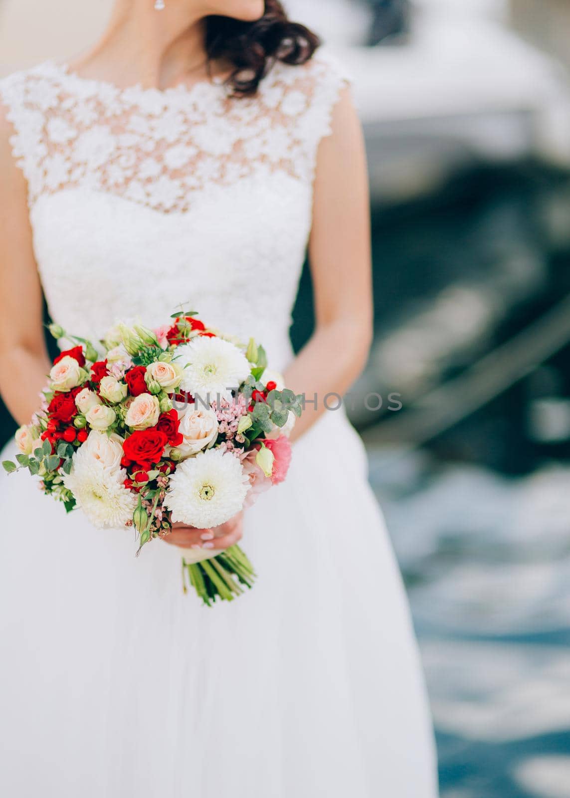 Wedding bridal bouquet of roses, chrysanthemums, Eucalyptus Baby Blue in the hands of the bride. Wedding in Montenegro, Adriatic.