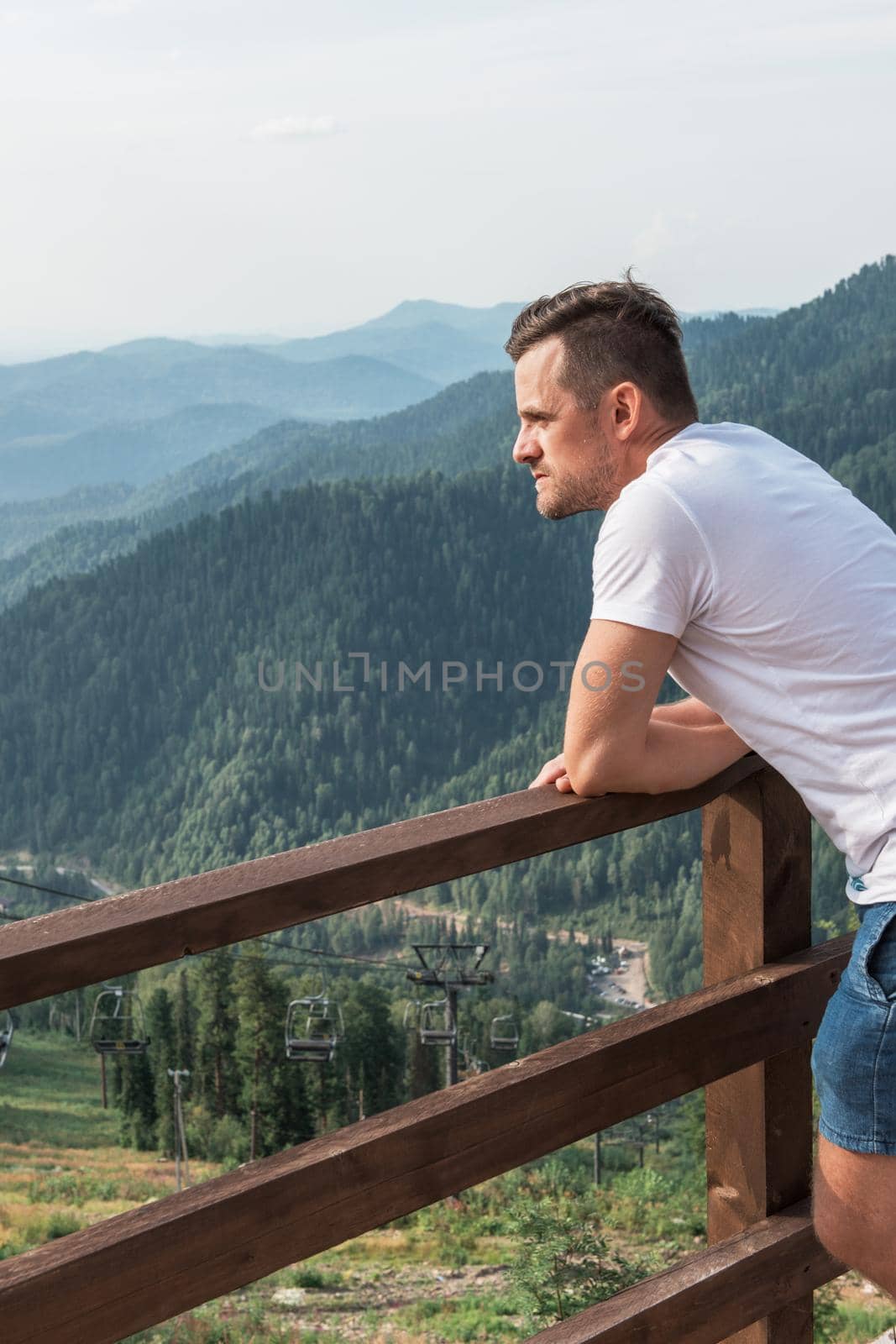 Man standing and looking into the distance in mountains