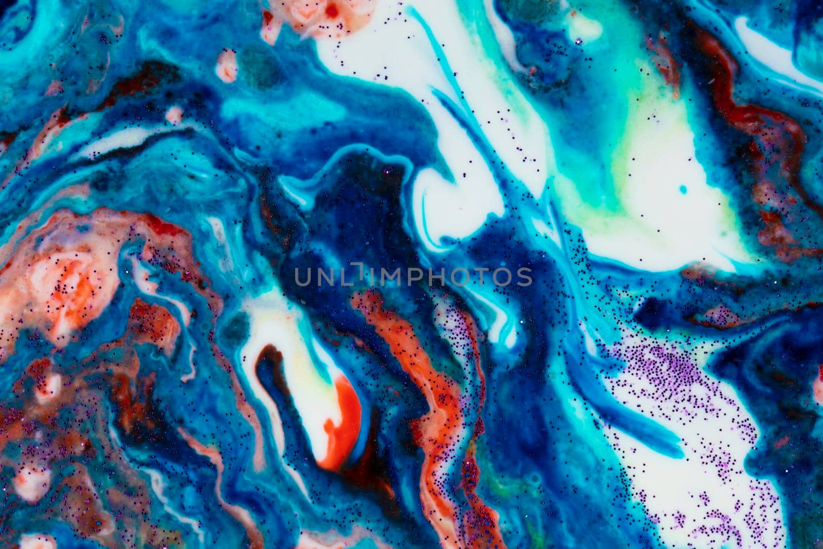 The background is acrylic blue with red lines and sparkles. Colorful marble texture. Fluid liquid marble. Art picture. Avant-garde creativity.