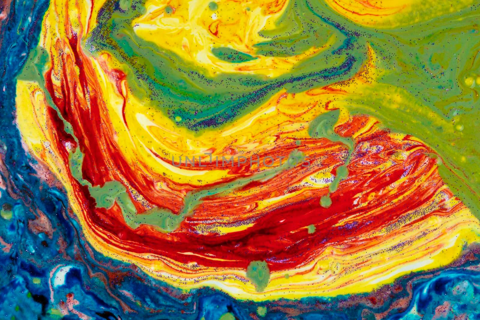 Multicolored marble acrylic background. A smudged spot of various paints covered with sequins. Colorful avant-garde texture.