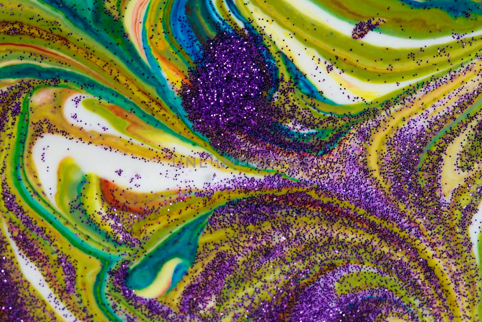 Multicolored acrylic backdrop sprinkled with purple sparkles. Contemporary creativity. Colorful avant-garde rich texture. A background made up of many shapes and materials.
