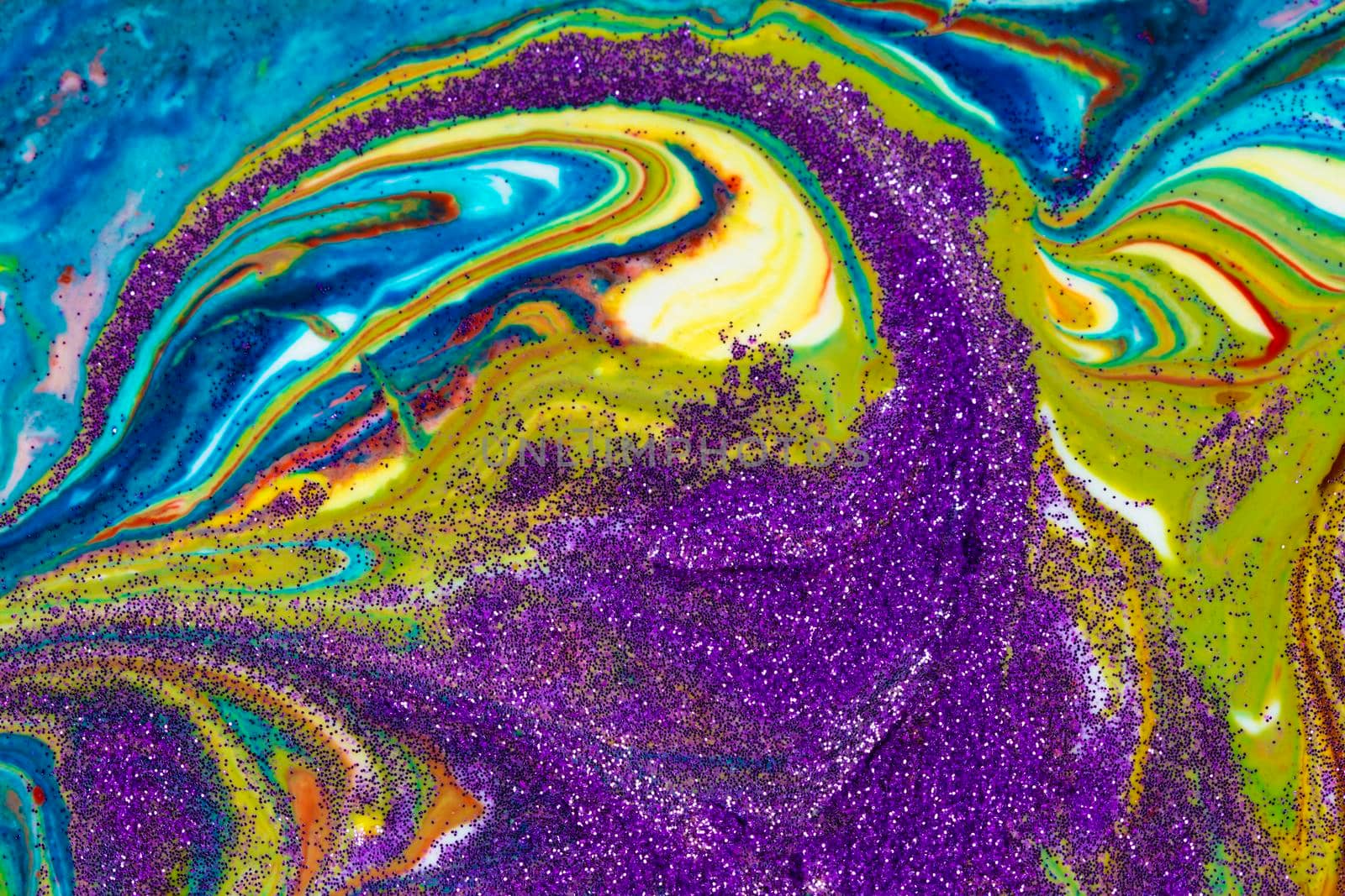 Multicolored acrylic backdrop sprinkled with purple sparkles. Contemporary creativity. Colorful avant-garde rich texture. A background made up of many shapes and materials.