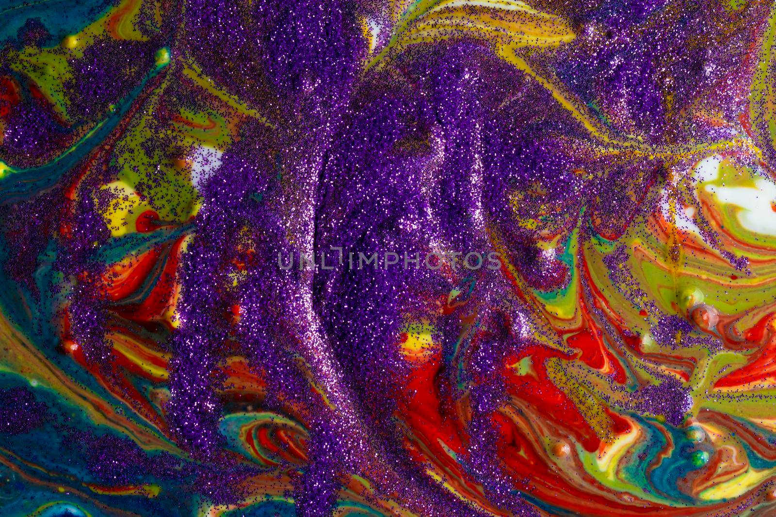 Multicolored acrylic backdrop sprinkled with purple sparkles. Contemporary creativity. Colorful avant-garde rich texture. A background made up of many shapes and materials.