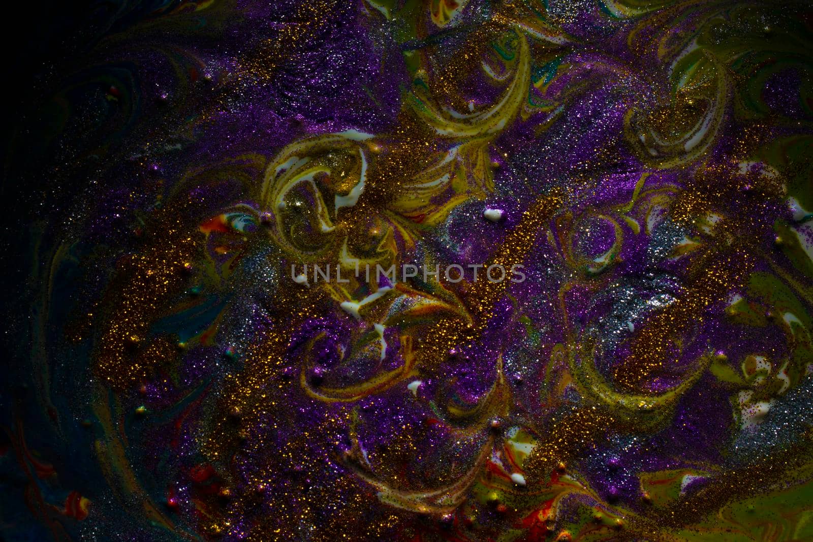 Multi-colored dark background sprinkled with purple and gold sparkles. Contemporary creativity. A colorful avant-garde painting with rich texture. A background made up of many shapes and materials.