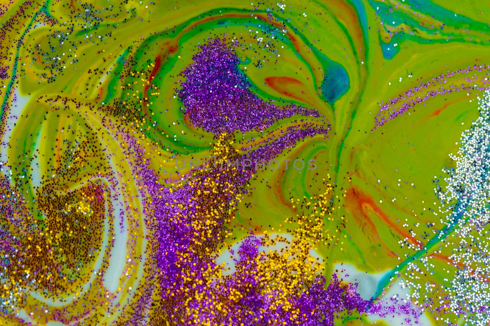 Multicolored acrylic background with curls sprinkled with purple and gold sparkles. Contemporary creativity. A colorful avant-garde painting with rich texture. A background made up of many shapes and materials.