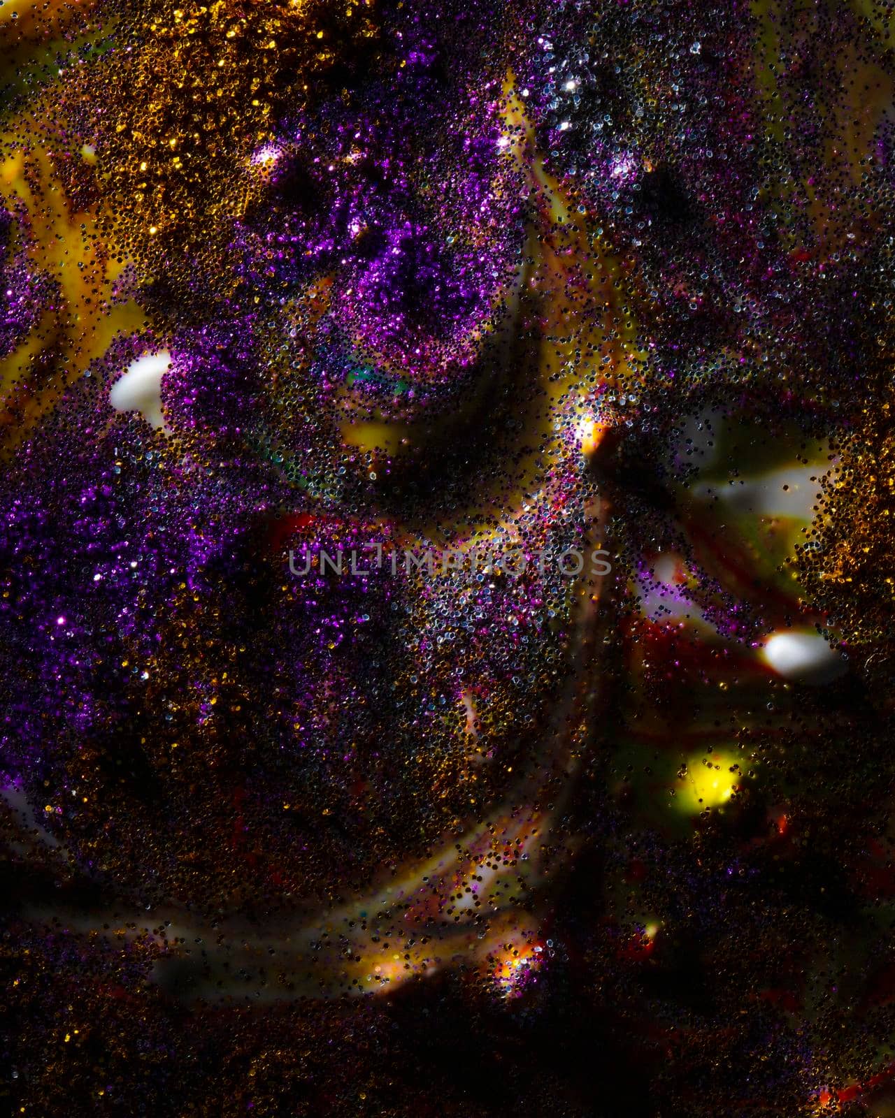 Vertically on a dark background, sprinkled with purple and gold sparkles with streaks and waves. Contemporary creativity. A colorful avant-garde painting with rich texture. A background made up of many shapes and materials.