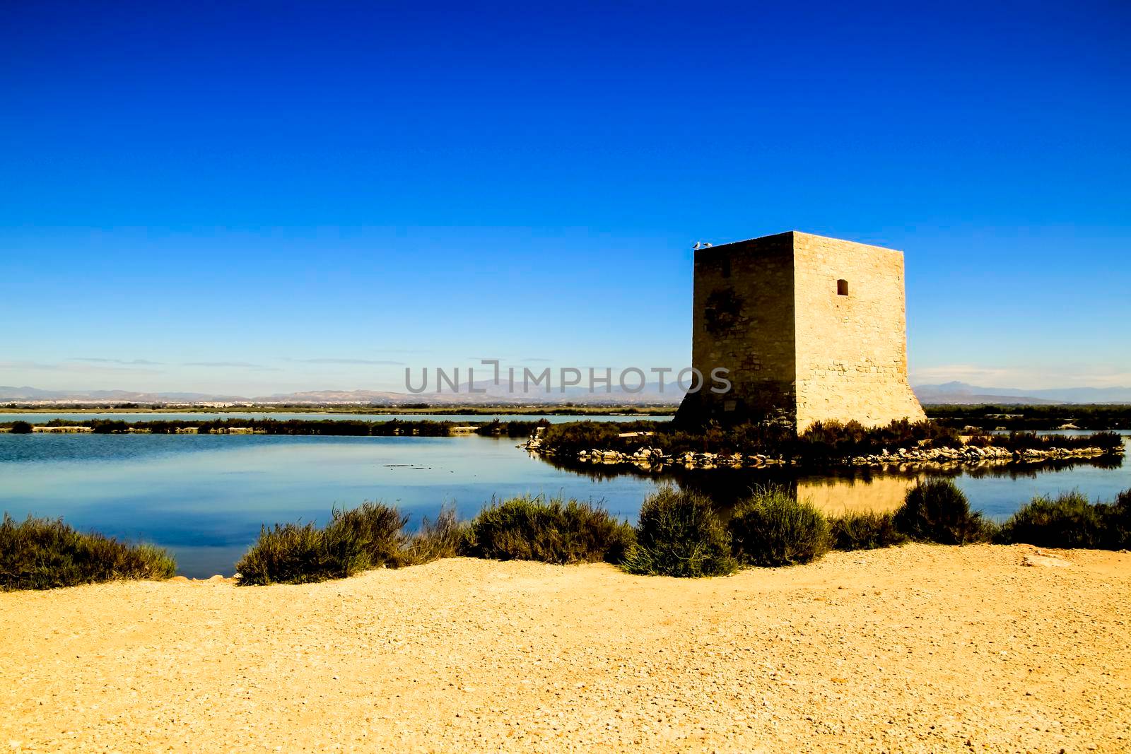 Beautiful Tamarit tower surrounded by salt lagoons in Santa Pola, Alicante, Spain