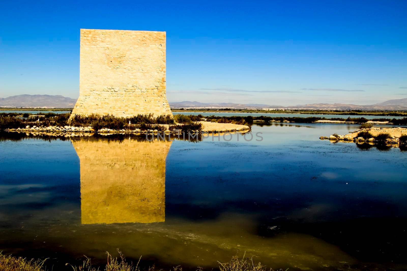Beautiful Tamarit tower surrounded by salt lagoons in Santa Pola, Alicante, Spain