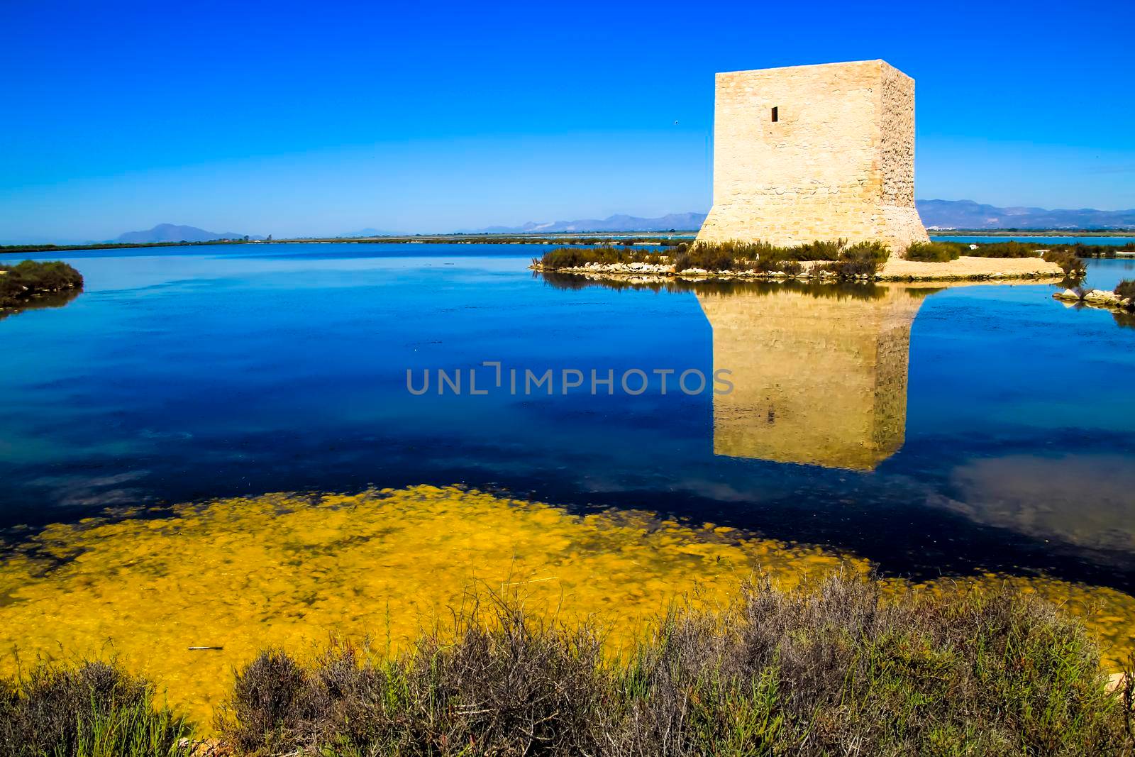 Beautiful Tamarit tower surrounded by salt lagoons in Santa Pola, Alicante, Spain