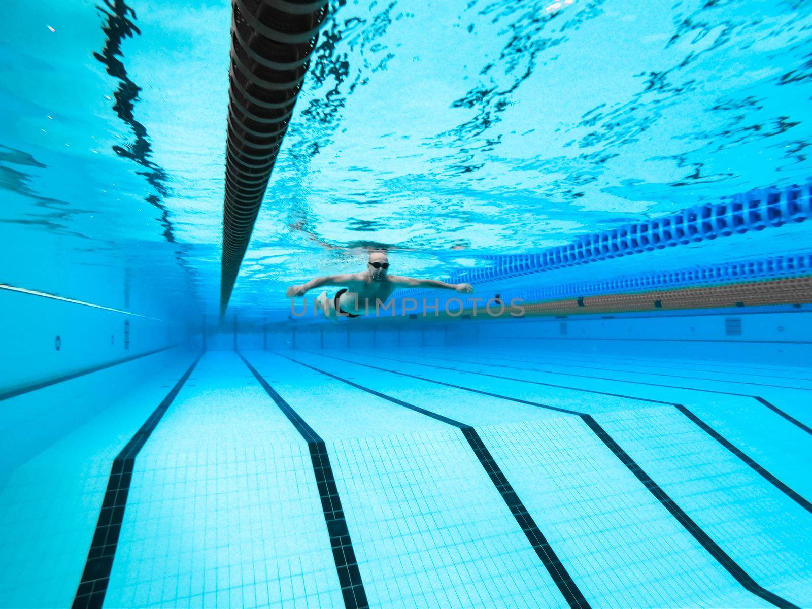 swimming in the pool at the swimming stadium.