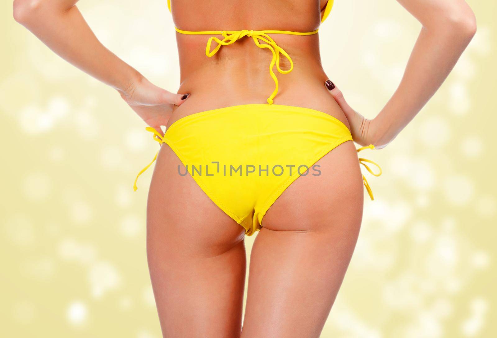 Sexy backside in yellow swimwear by Nobilior