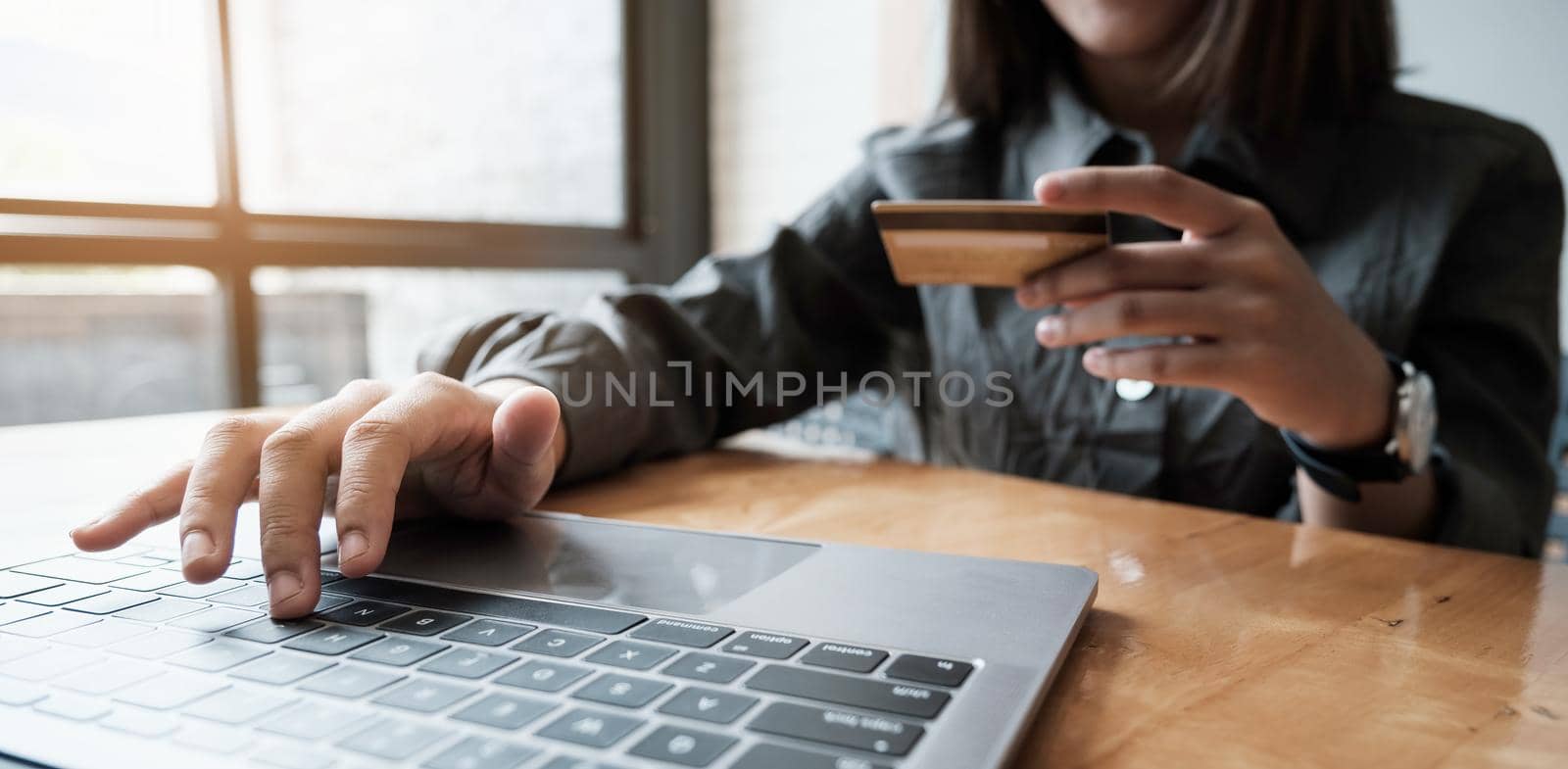 Woman enjoy with online shopping application and looking at credit card for fill number to payment. by itchaznong