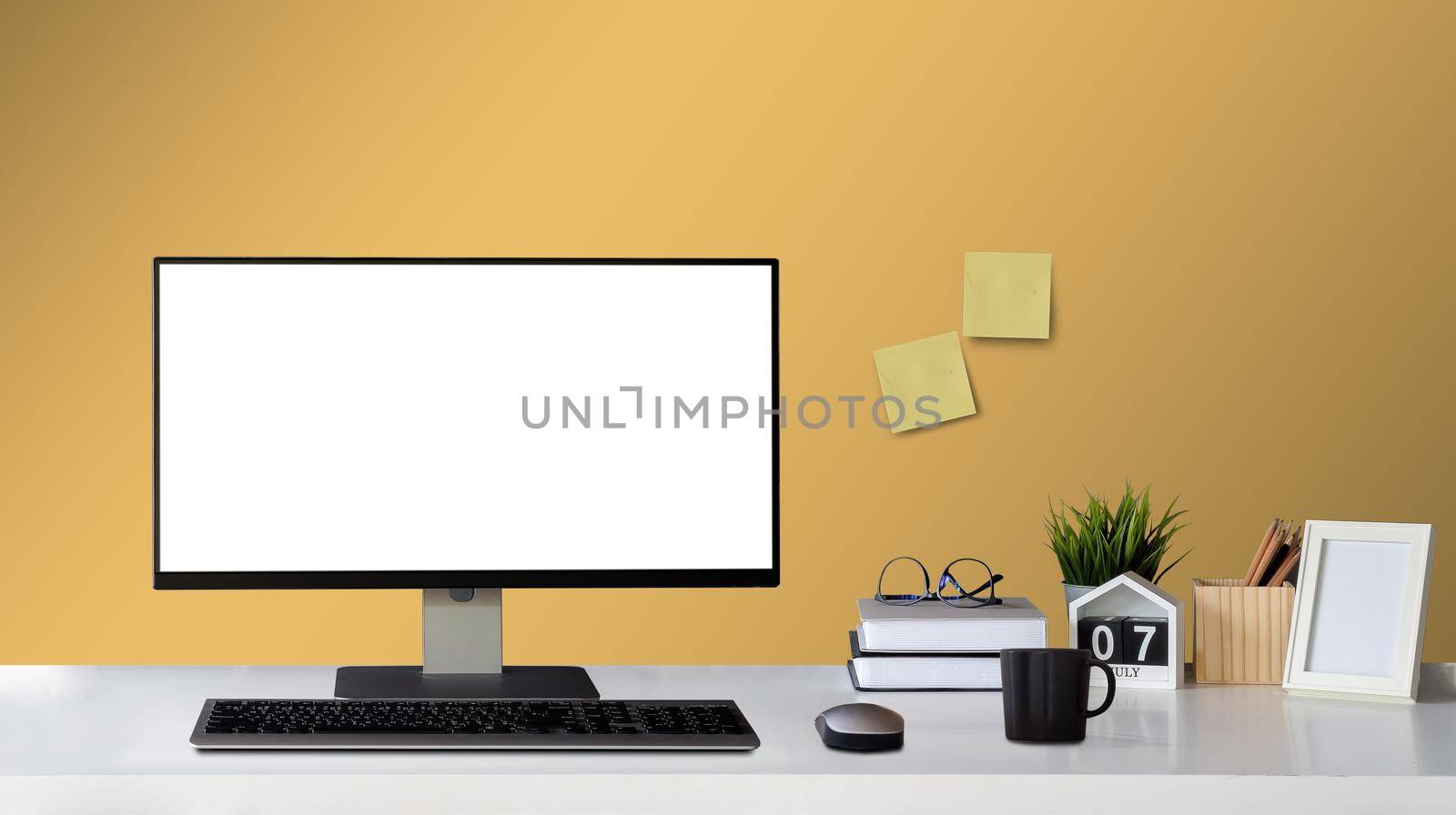 Mock up computer with blank white screen and Office Supply Items on Word Desk home decor with picture frame workspace with copy space for products display montage. by nateemee