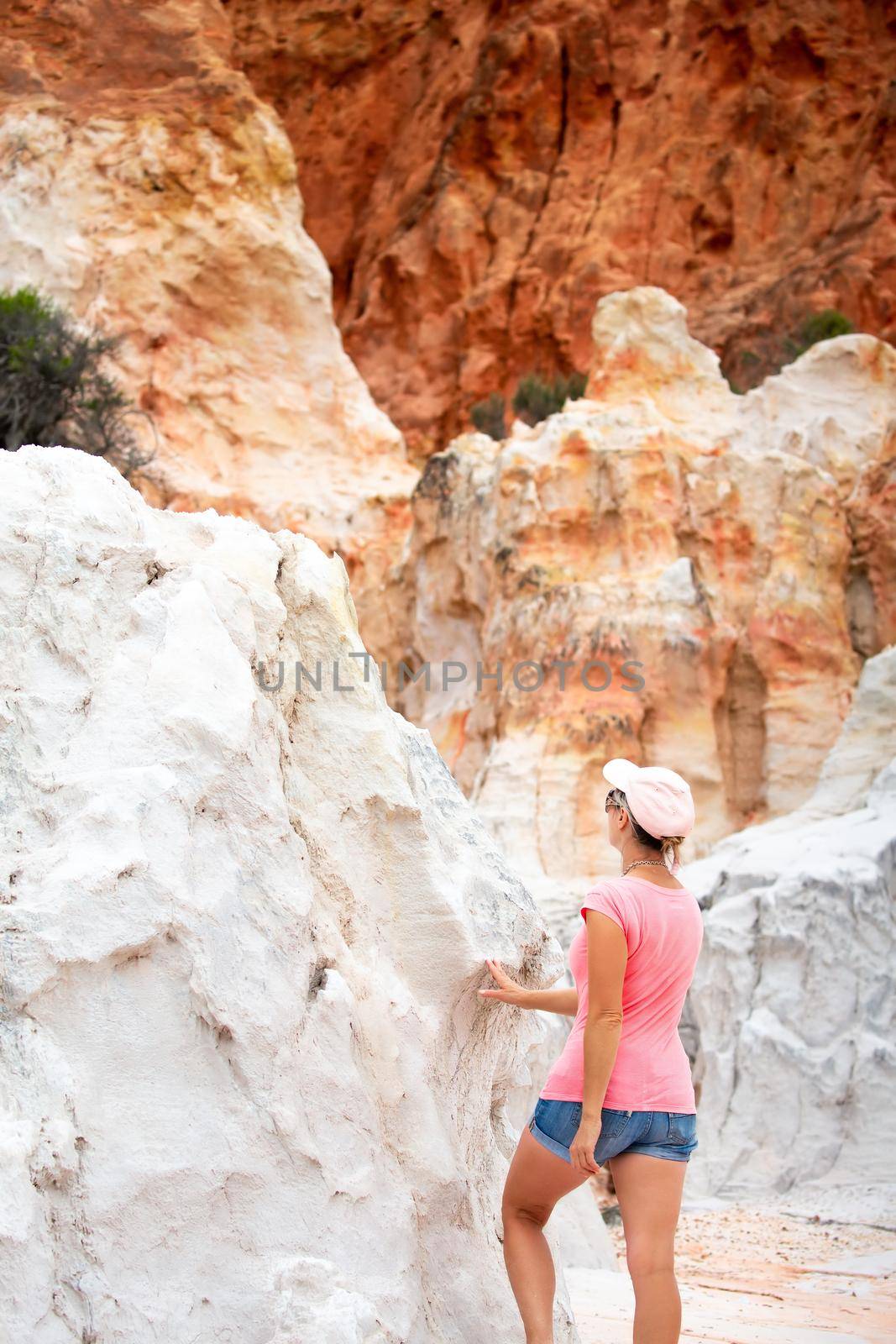 Female traveller exploring the remarkable red and white cliffs of Ben Boyd in Eden Australia