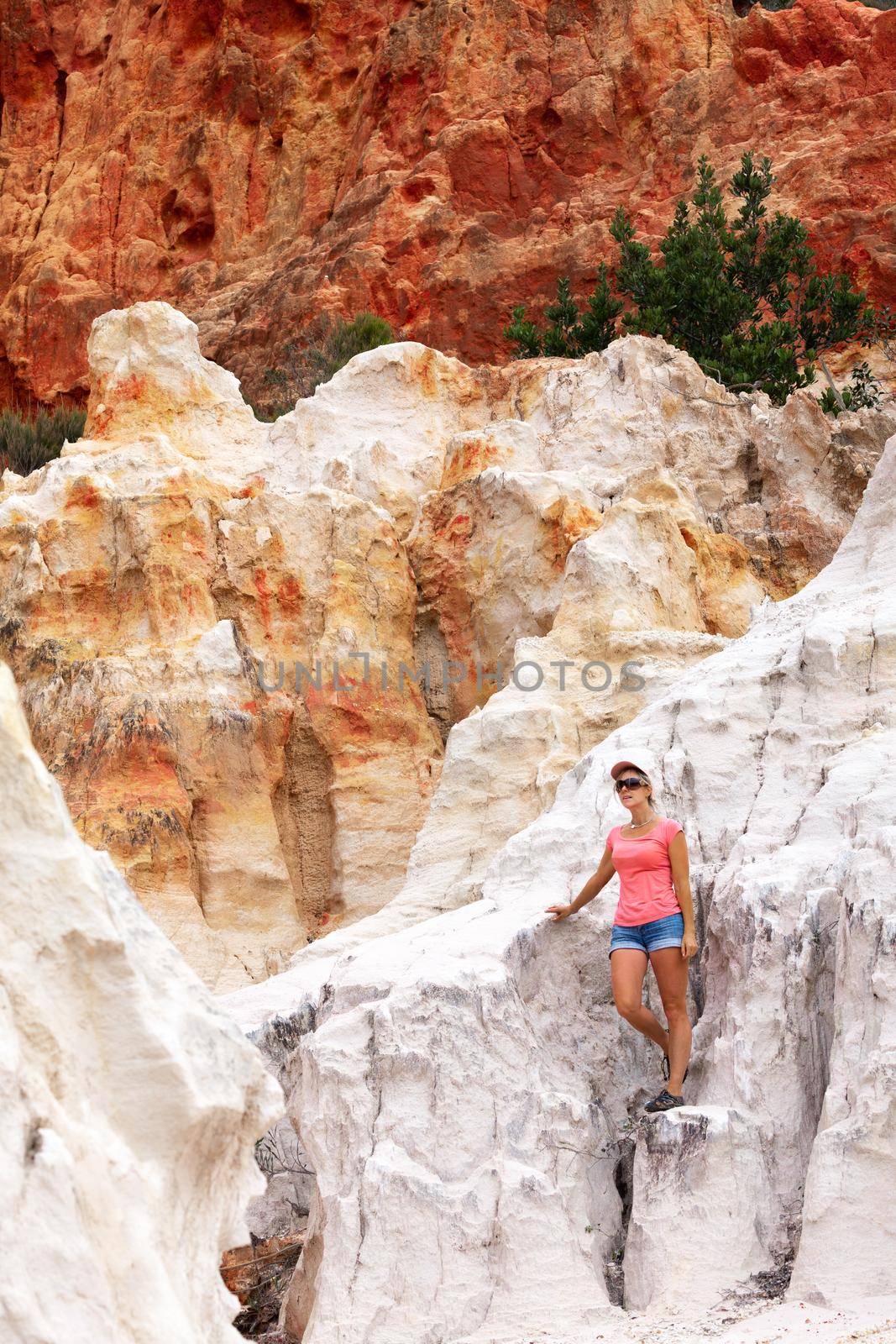 Tourist exploring the red and white cliffs of Ben Boyd in Australia by lovleah