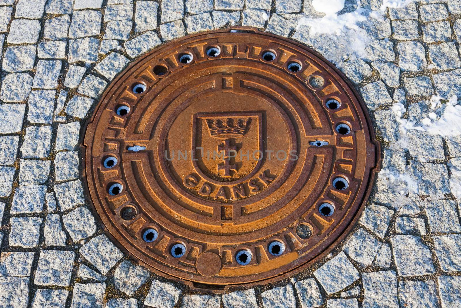 Manhole cover with Gdansk emblem. Gdansk, Pomerania, Poland.