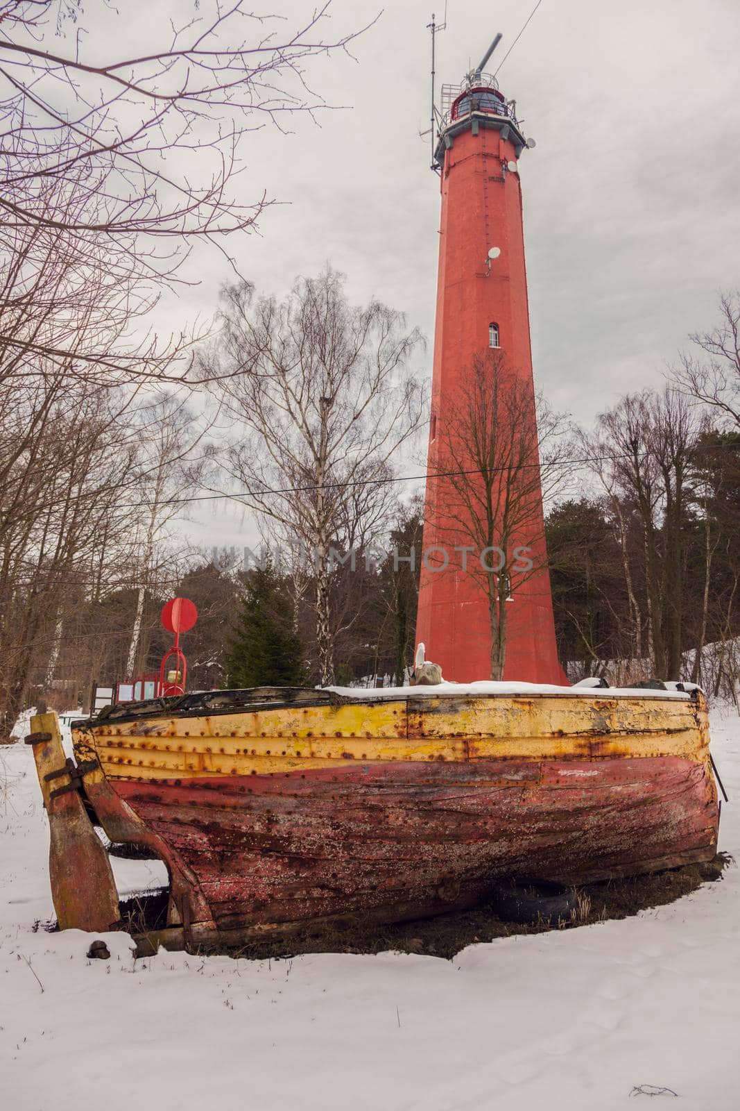 Lighthouse and old boat in Hel. Hel, Pomerania, Poland.