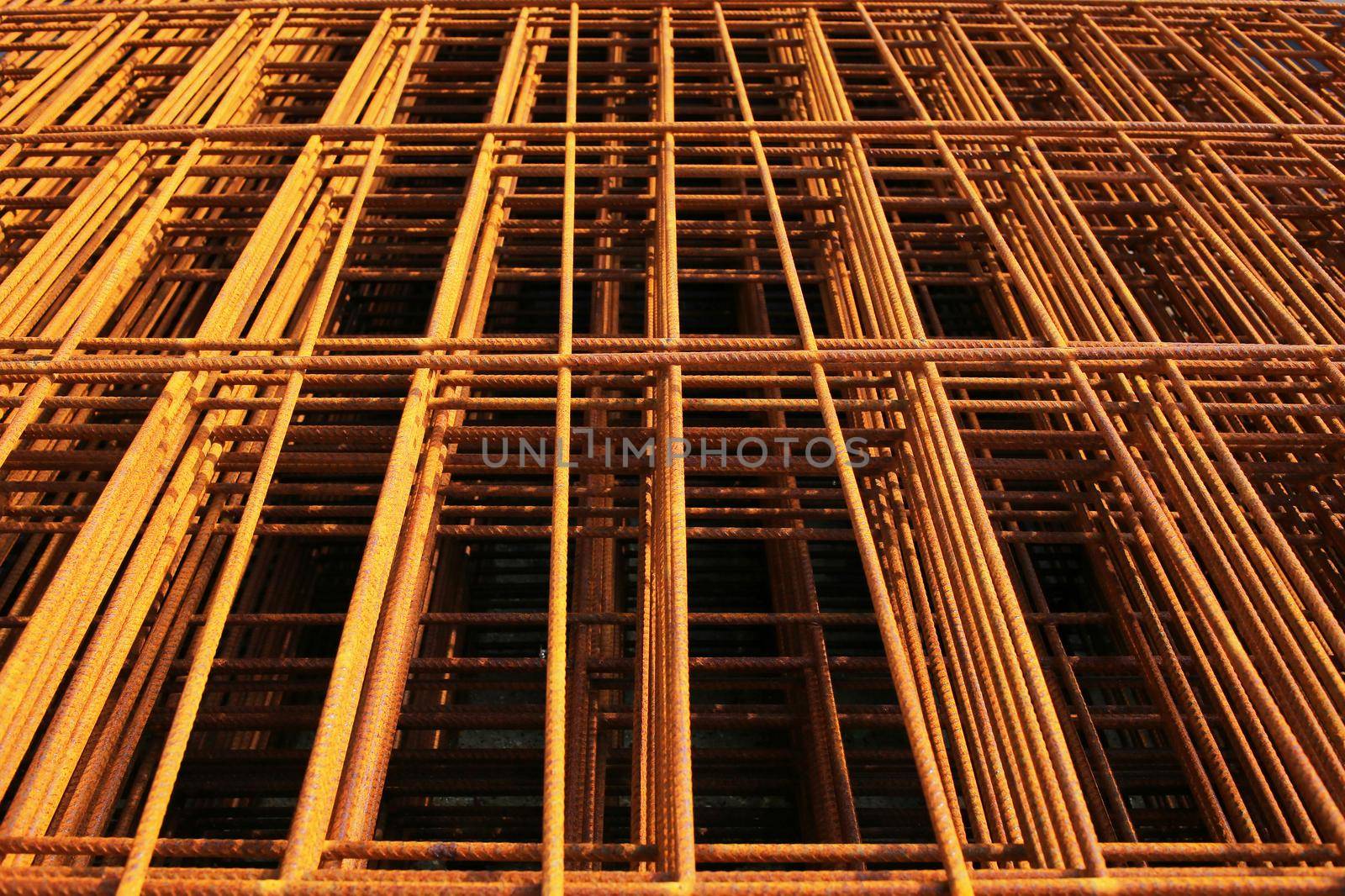 steel rebar for reinforcement concrete at construction site with house under construction background