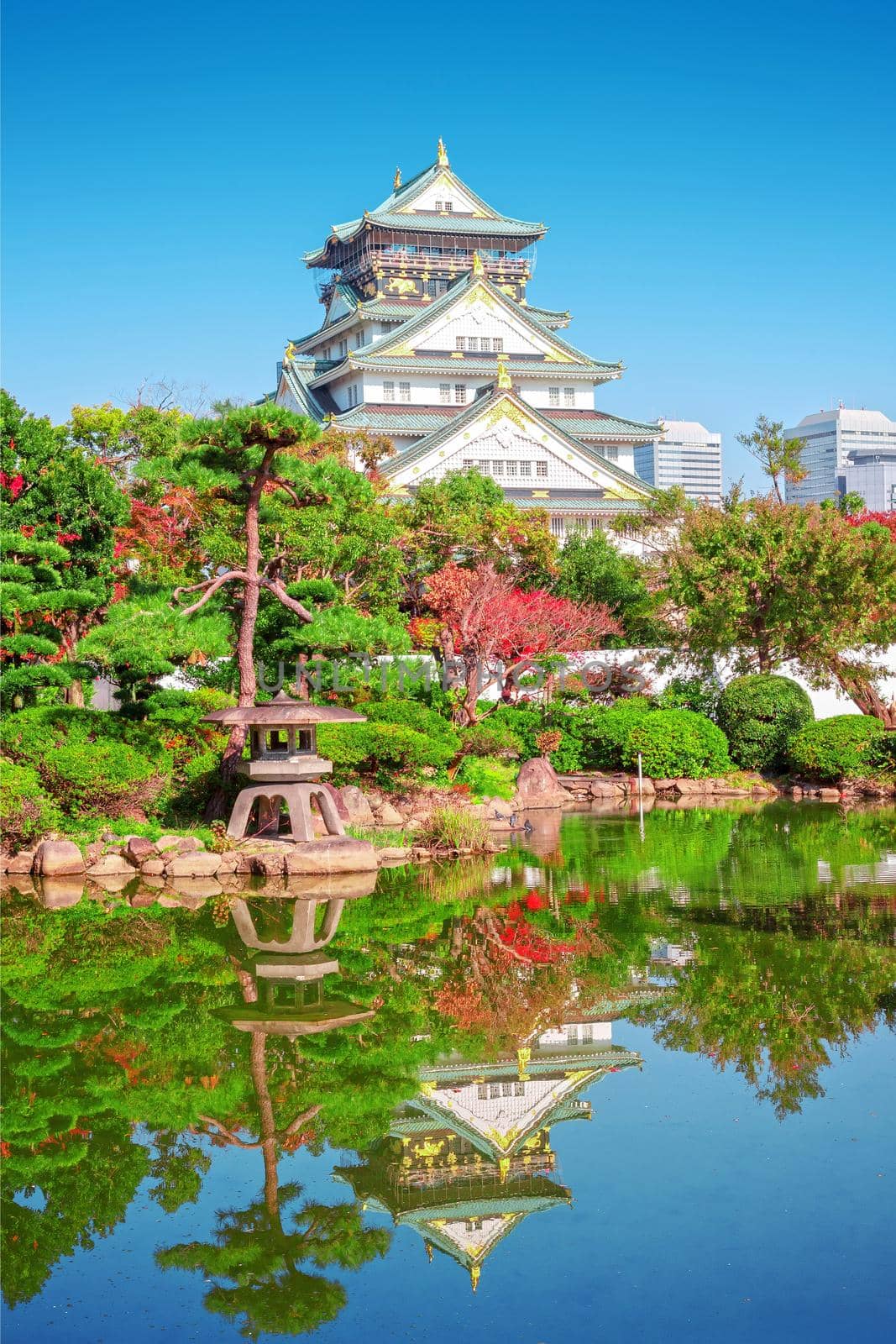 autumn scenery and modern buildings around moat river of osaka castle osaka japan