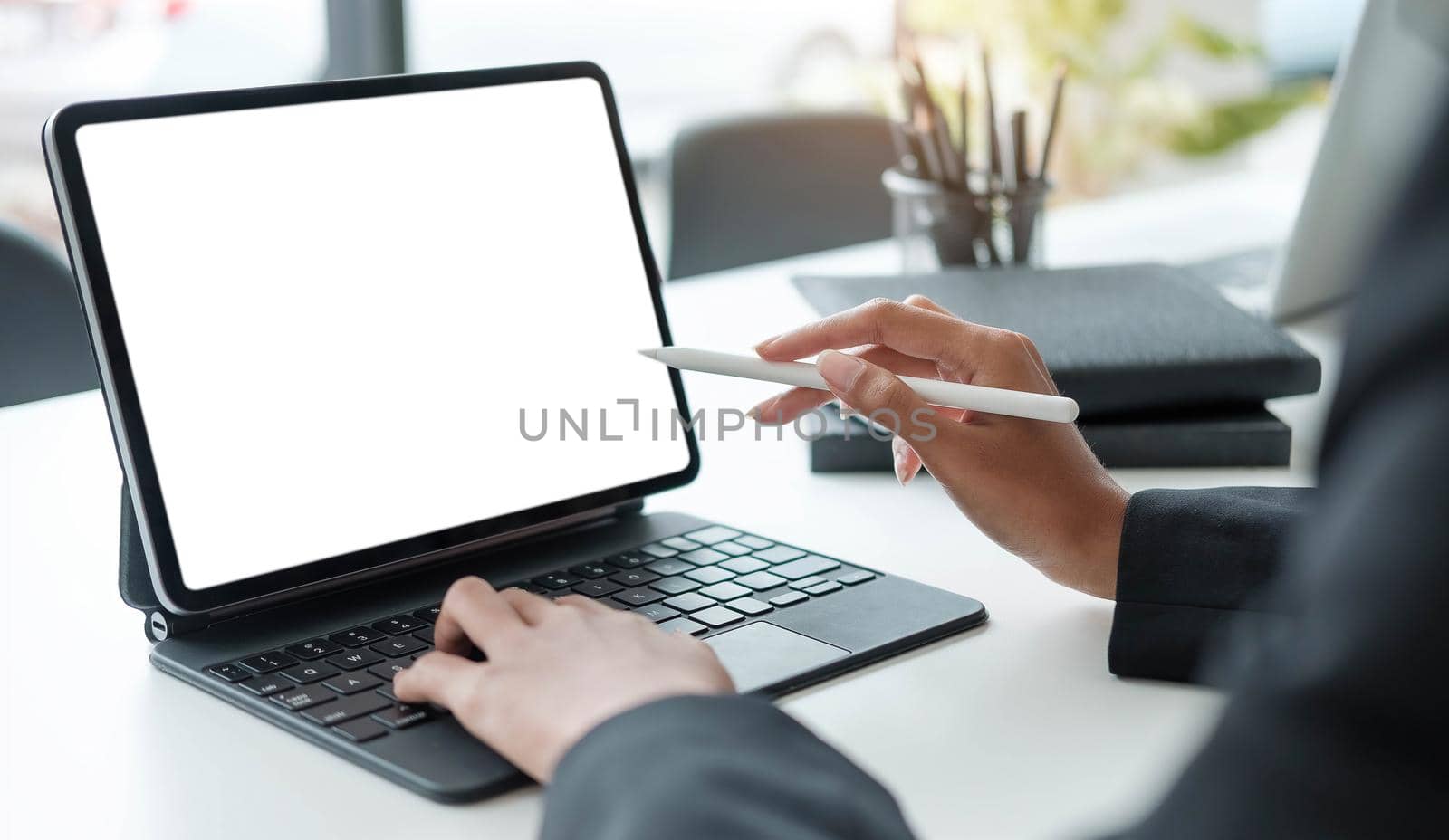 Close Up . Hands of woman designer using digital tablet to work at home or in the office..