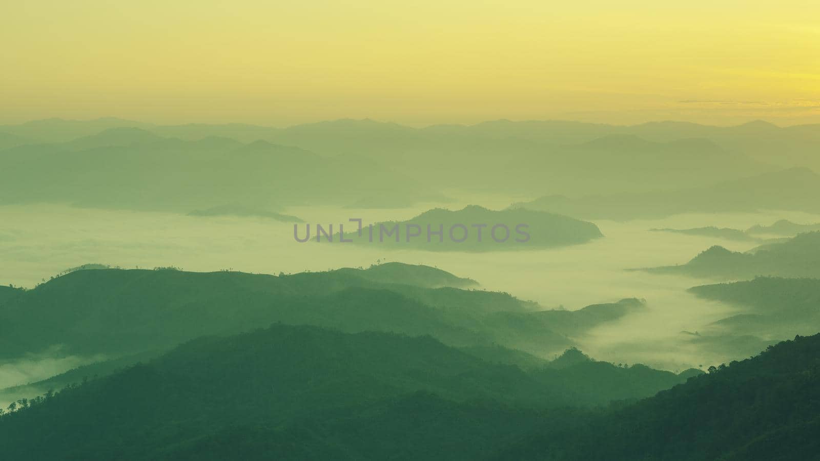 Landscape of mountain view with morning fog at sunrise time.