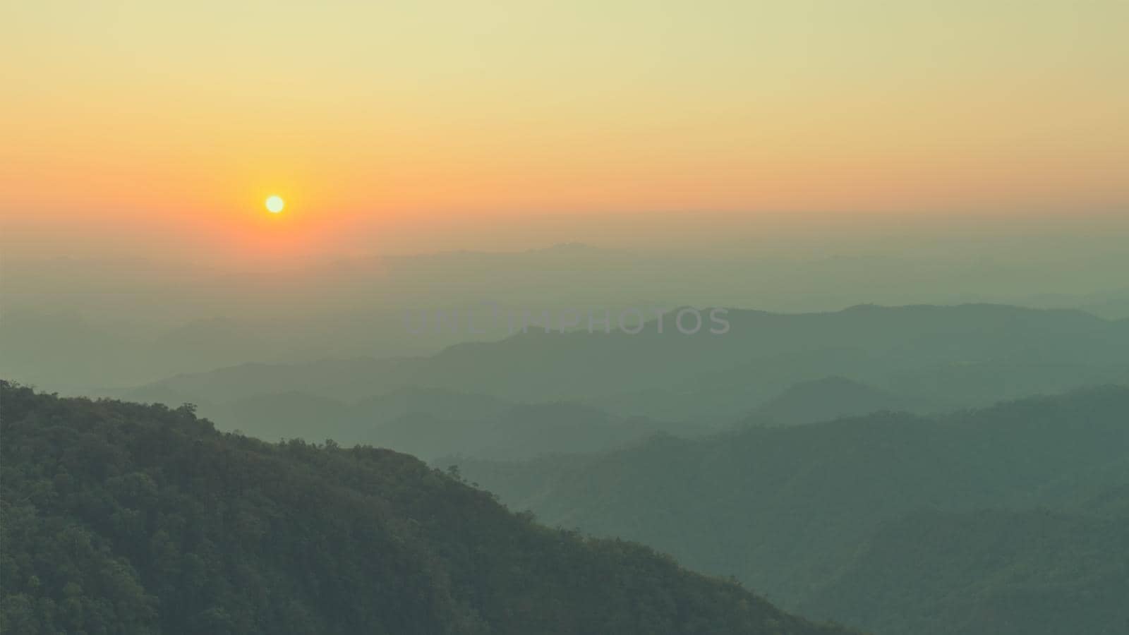 Colorful sunset in the mountains landscape. Dramatic overcast sky.