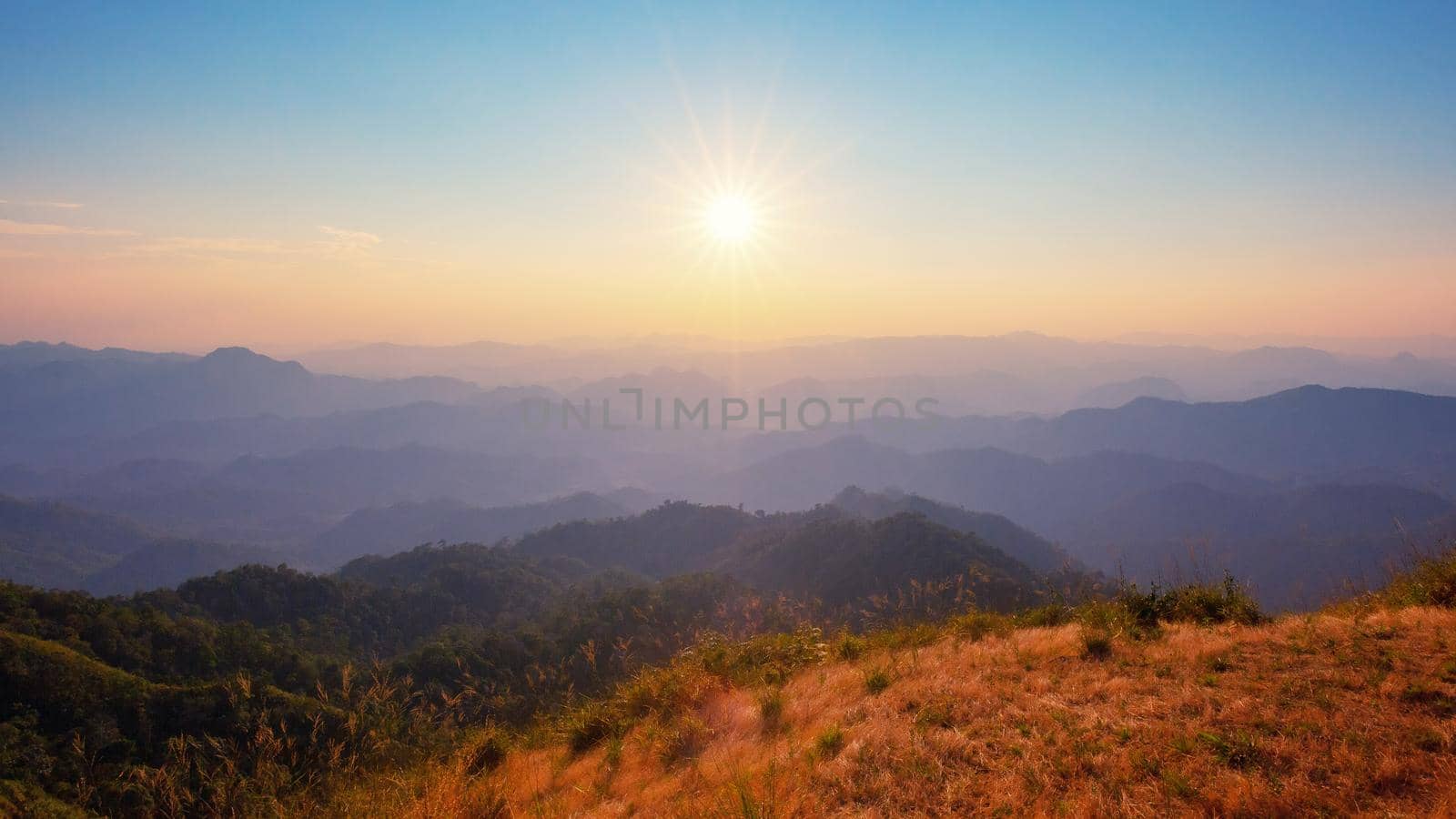 Colorful sunset in the mountains landscape. Dramatic overcast sky.