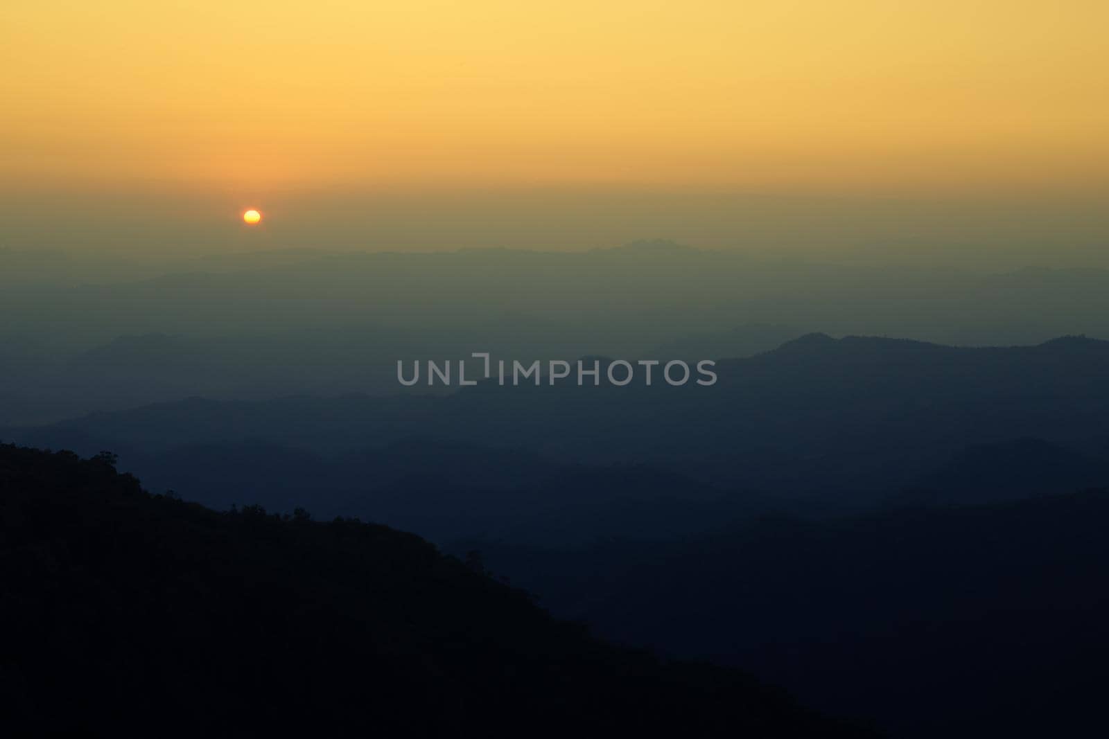 Colorful sunset in the mountains landscape. Dramatic overcast sky.