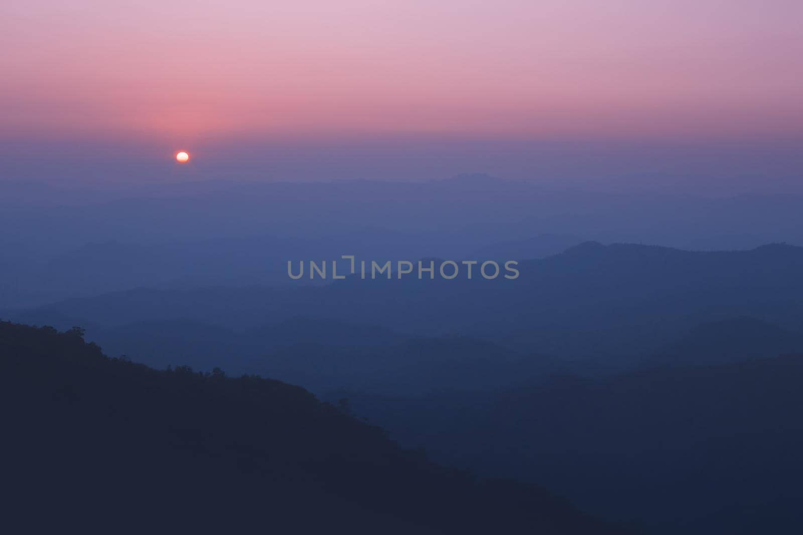 Colorful sunset in the mountains landscape. Dramatic overcast sky.