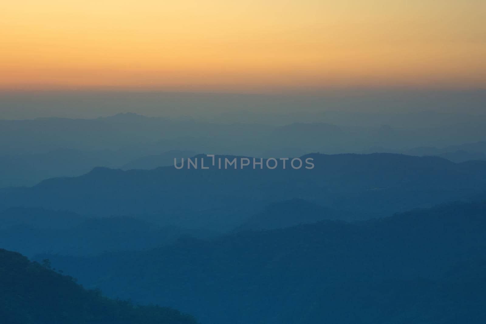 Colorful sunset in the mountains landscape. Dramatic overcast sky.