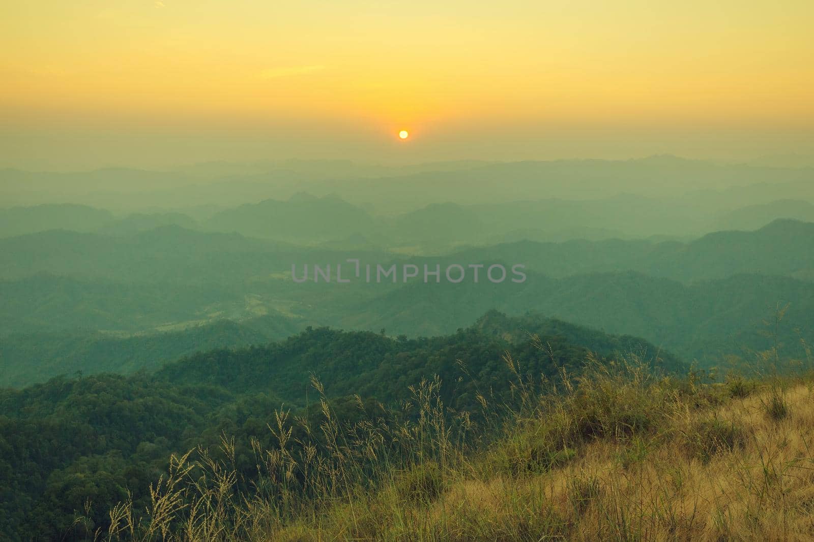 Colorful sunset in the mountains landscape. Dramatic overcast sky.