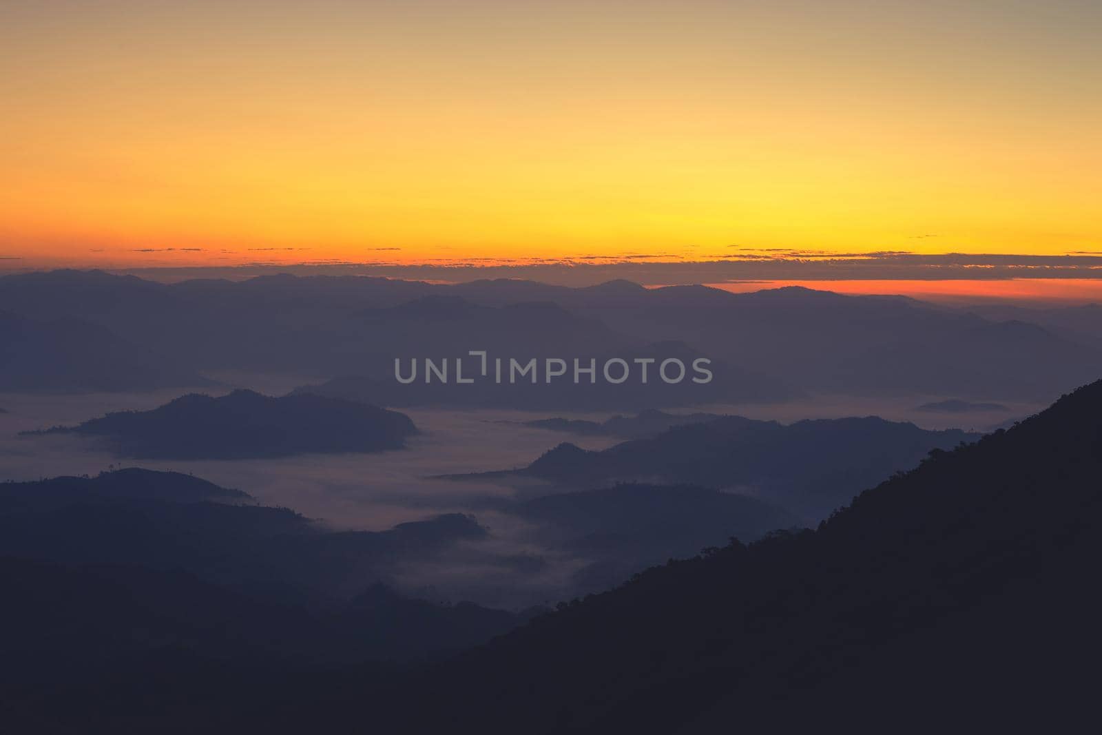 Landscape of mountain view with morning fog at sunrise time.