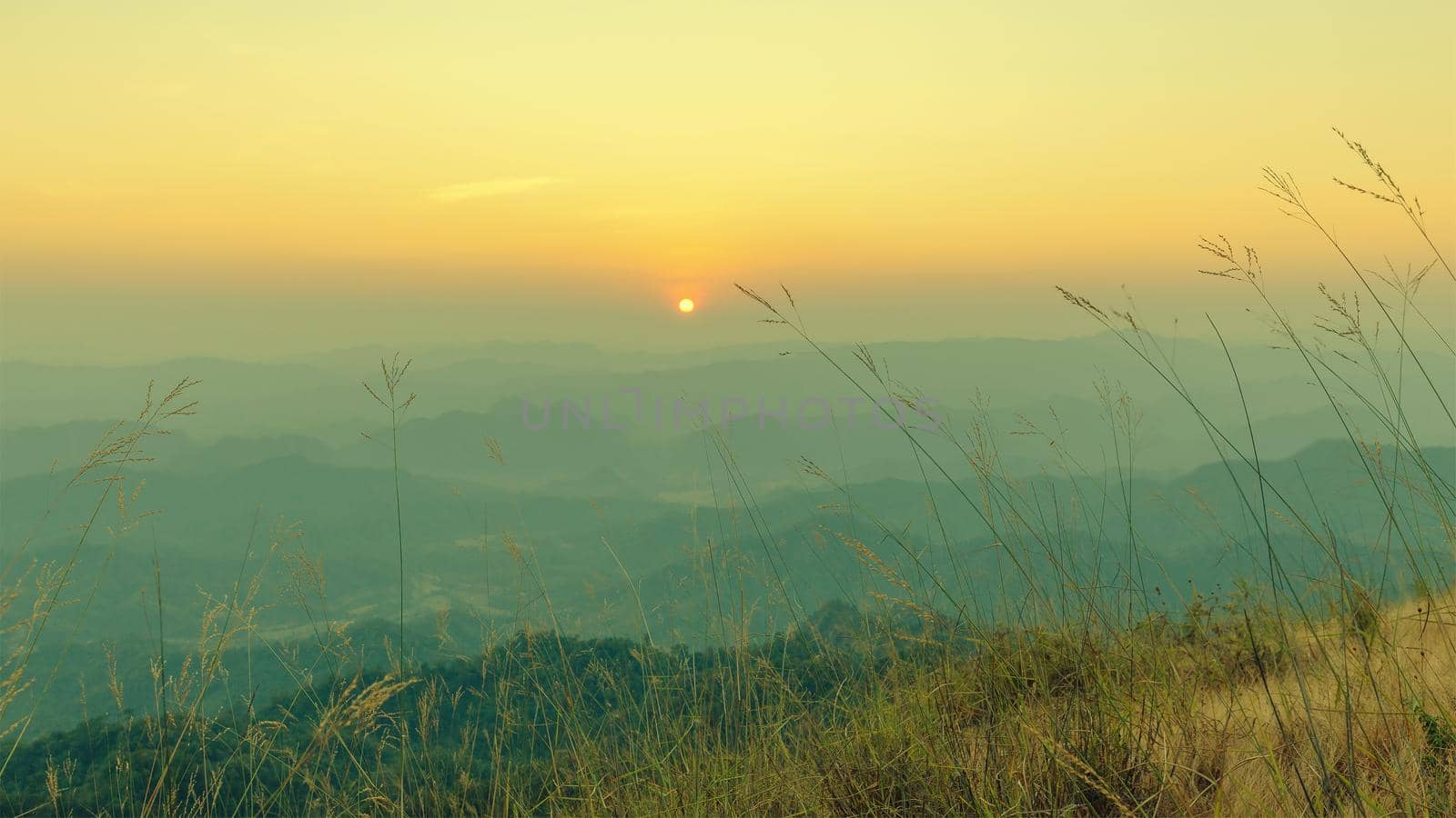 Colorful sunset in the mountains landscape. Dramatic overcast sky.
