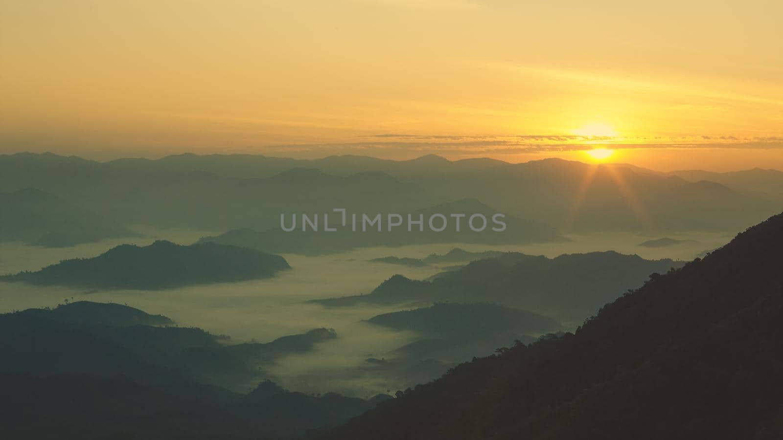 Colorful sunset in the mountains landscape. Dramatic overcast sky.