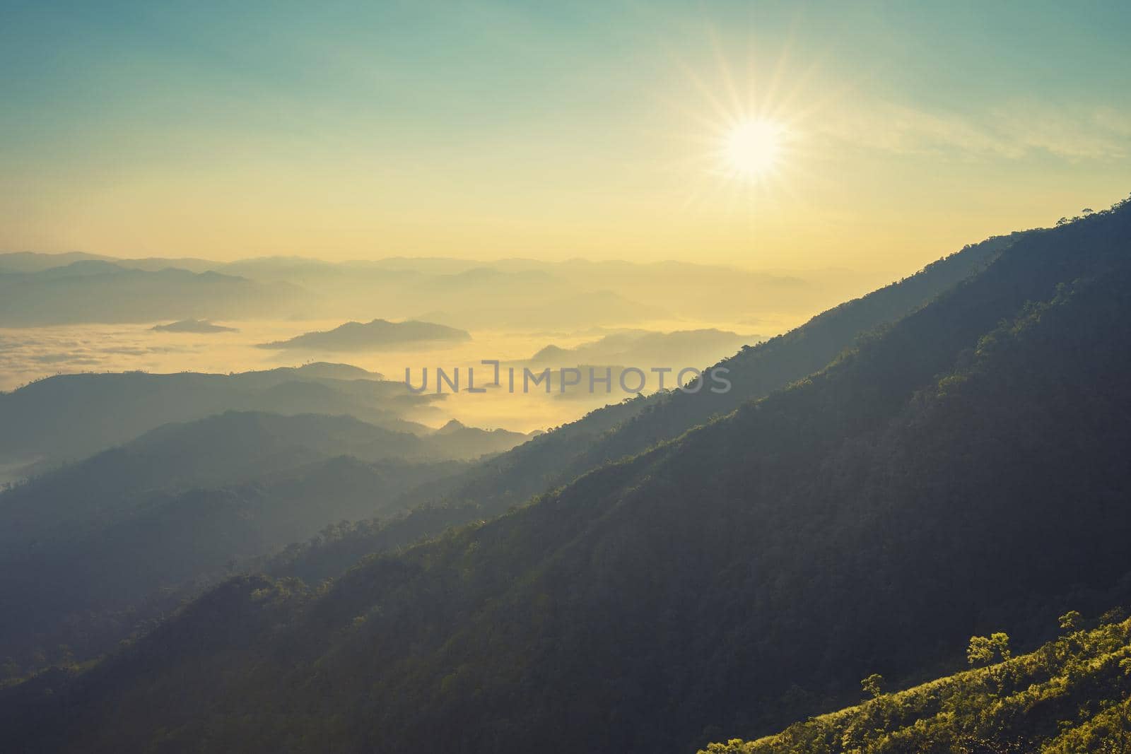 Colorful sunset in the mountains landscape. Dramatic overcast sky.