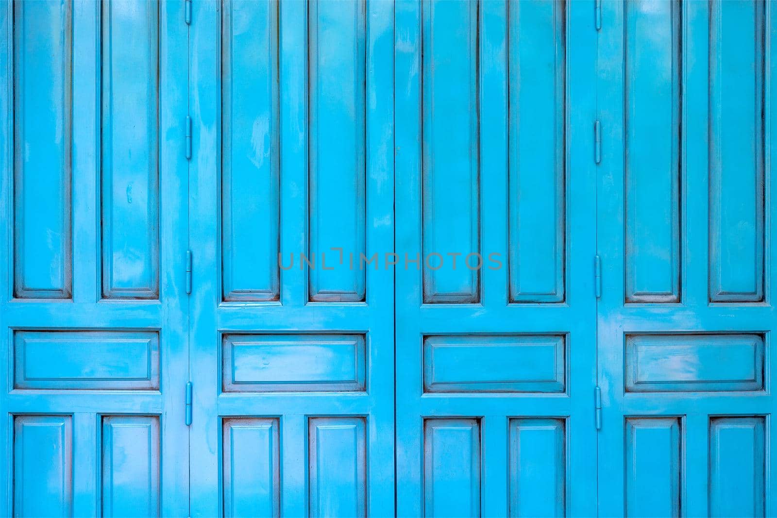 Closeup of the weathered old blue wood door background