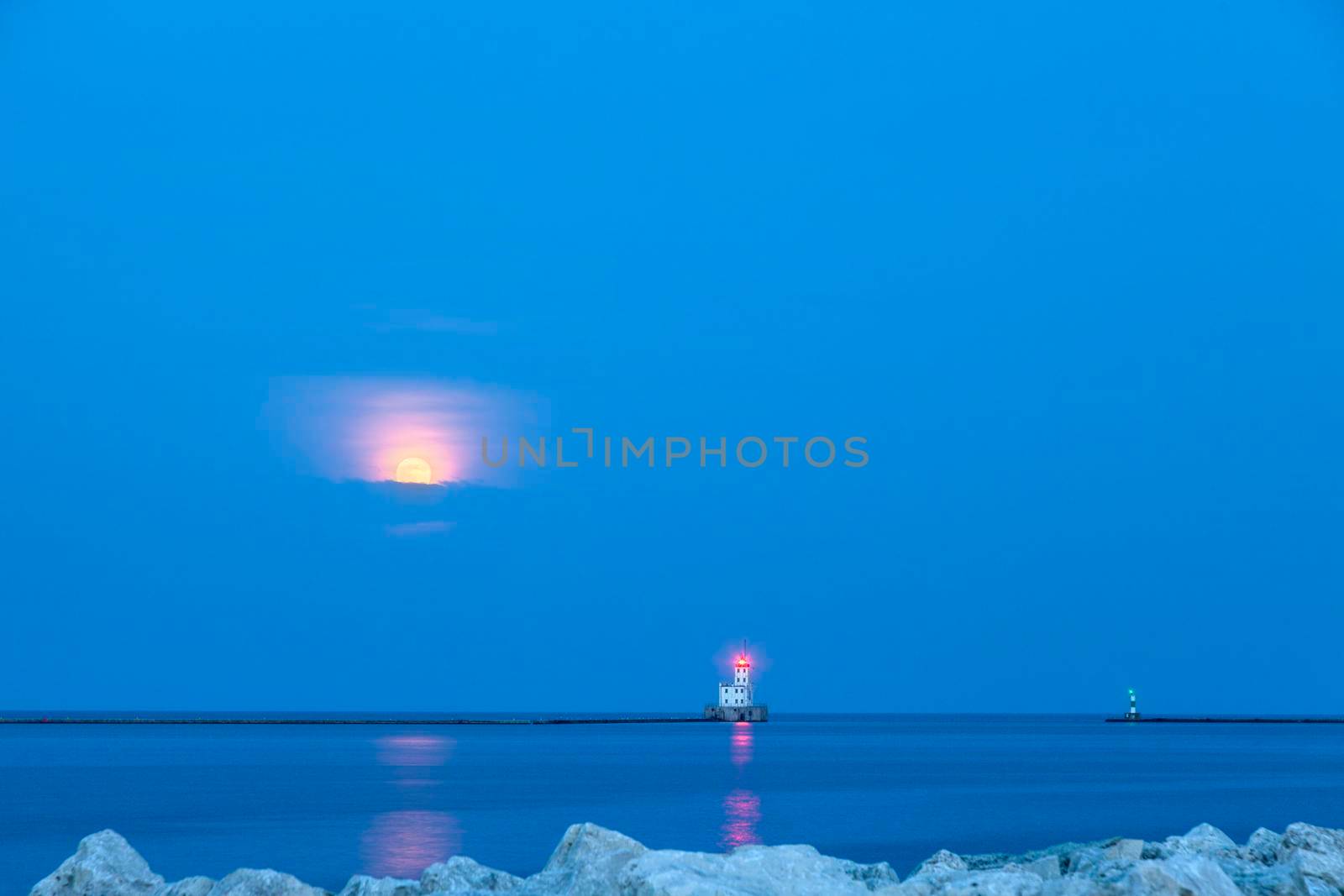 Milwaukee Breakwater Lighthouse and full moon. Milwaukee, Wisconsin, USA.