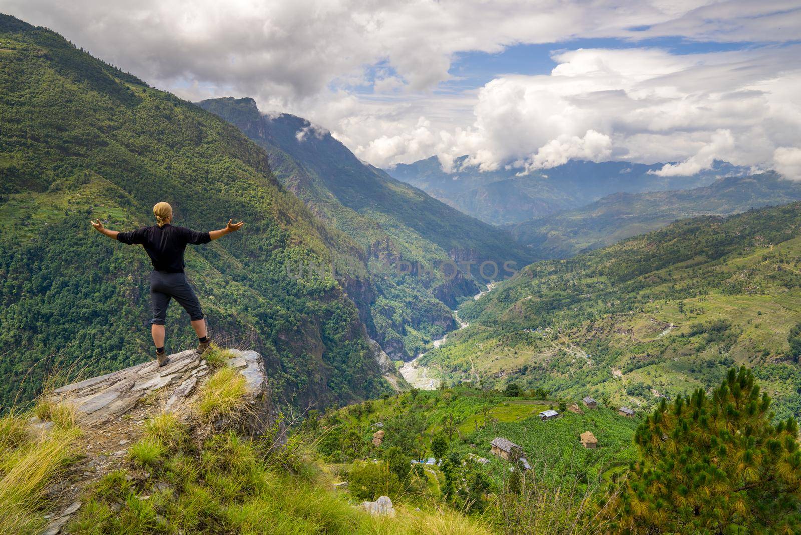 Man standing on top of the hill in Himalayas. Achievement and success. Trekking in Nepal