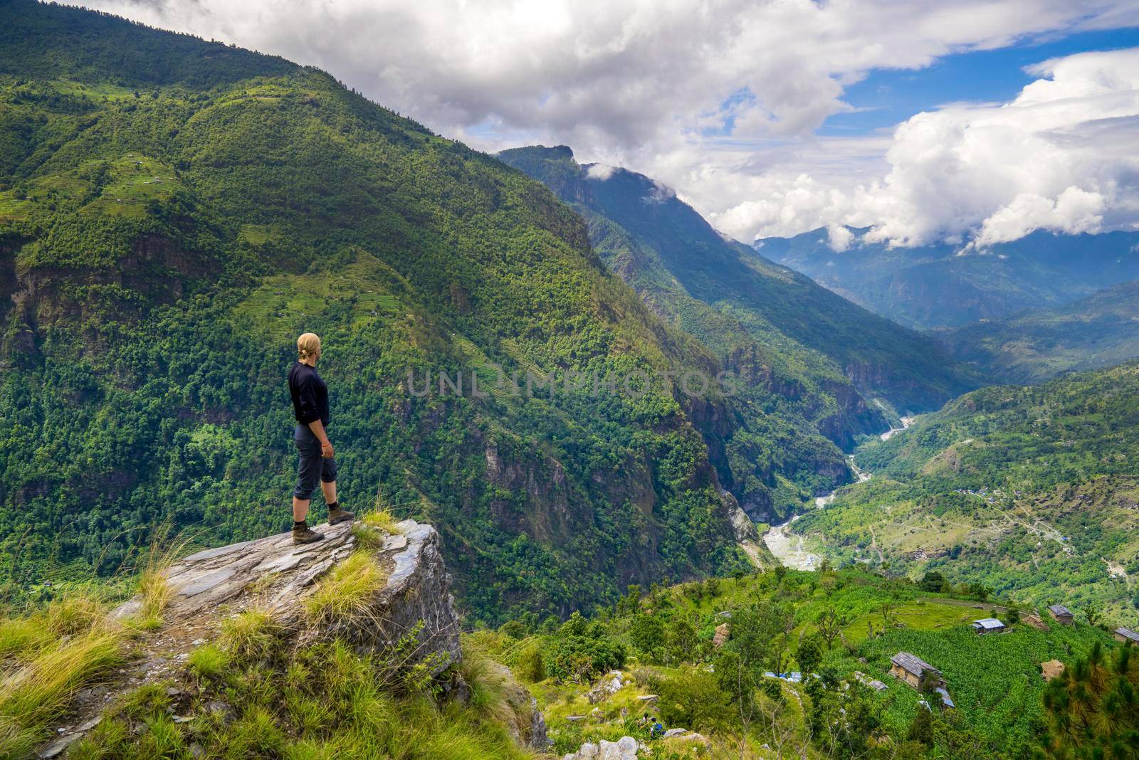 Man standing on top of the hill in Himalayas. Achievement and success. Trekking in Nepal