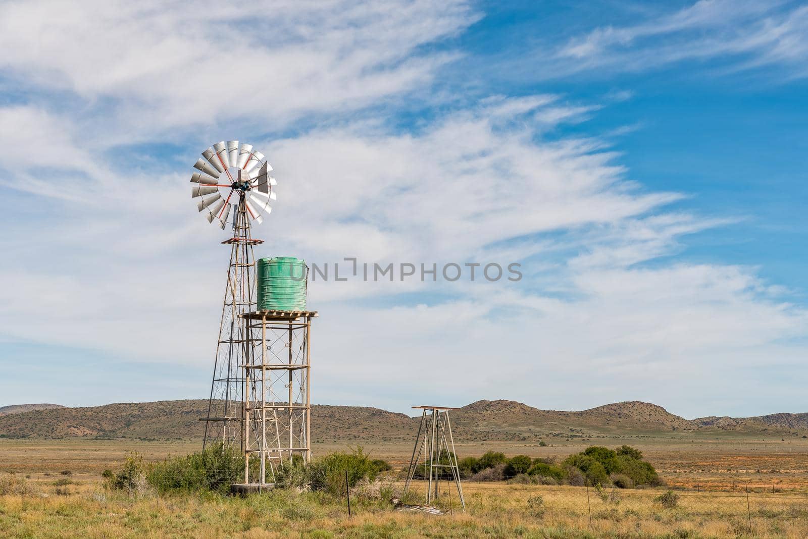 Water-pumping windmill and water tank on farm near Hanover by dpreezg
