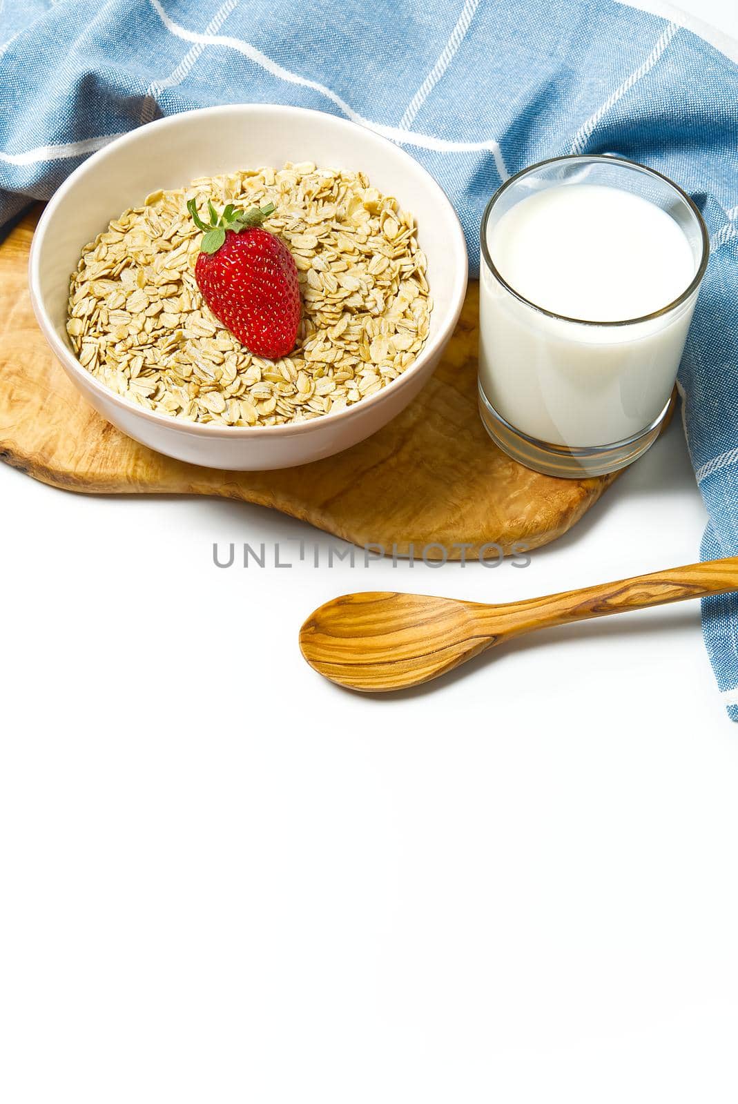 Healthy food. Oat flakes with fresh strawberry in white bowl, isolated on white background. copy space