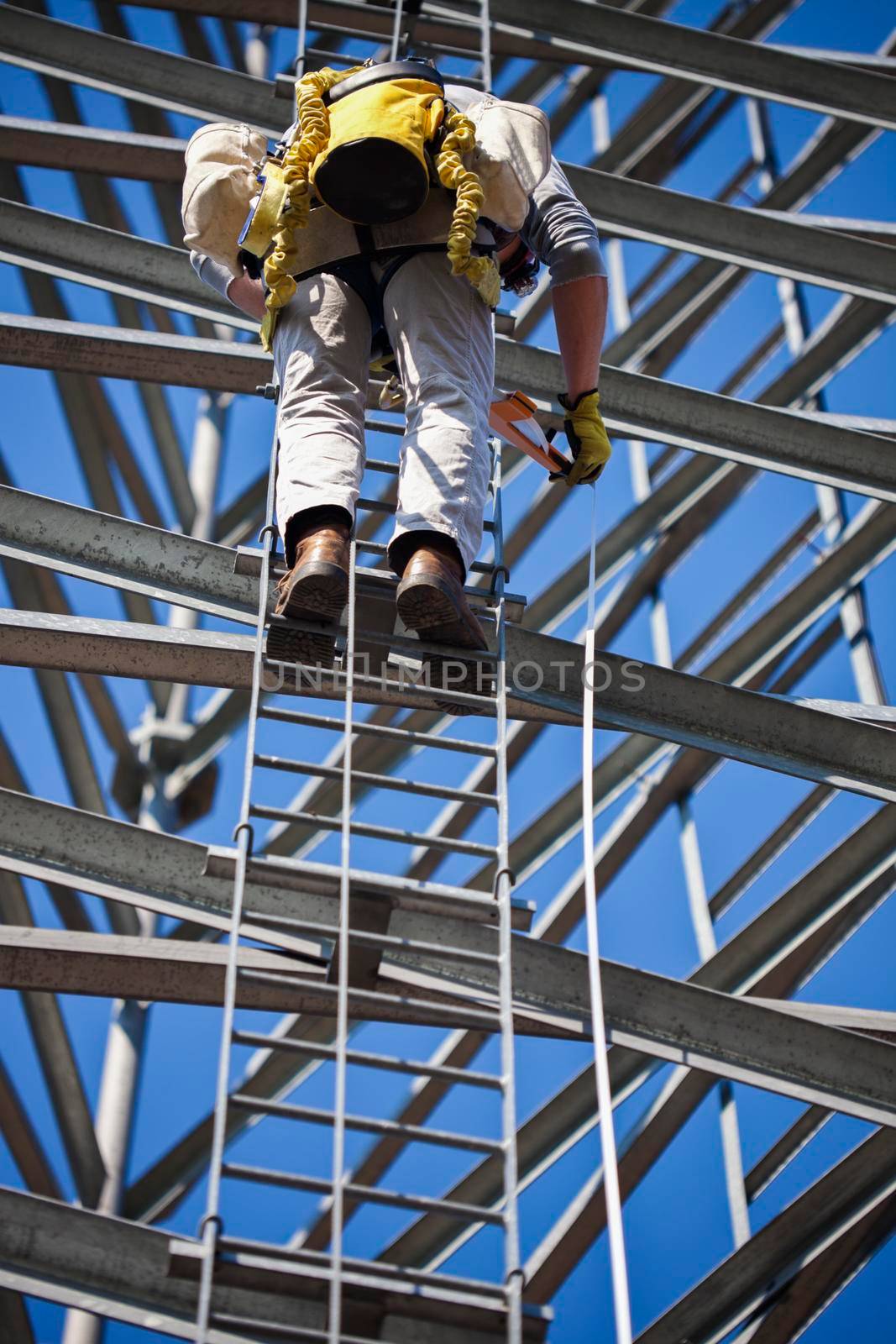 Climber ascending cell phone tower. Seen in USA.