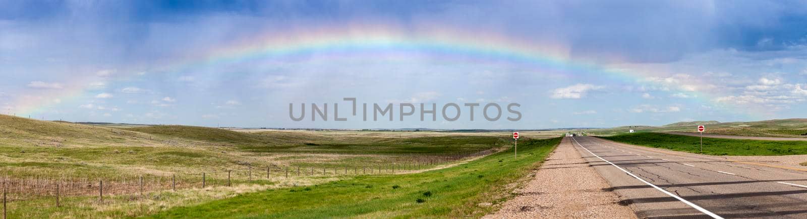 Rainbow over the highway in Saskatchewan by benkrut