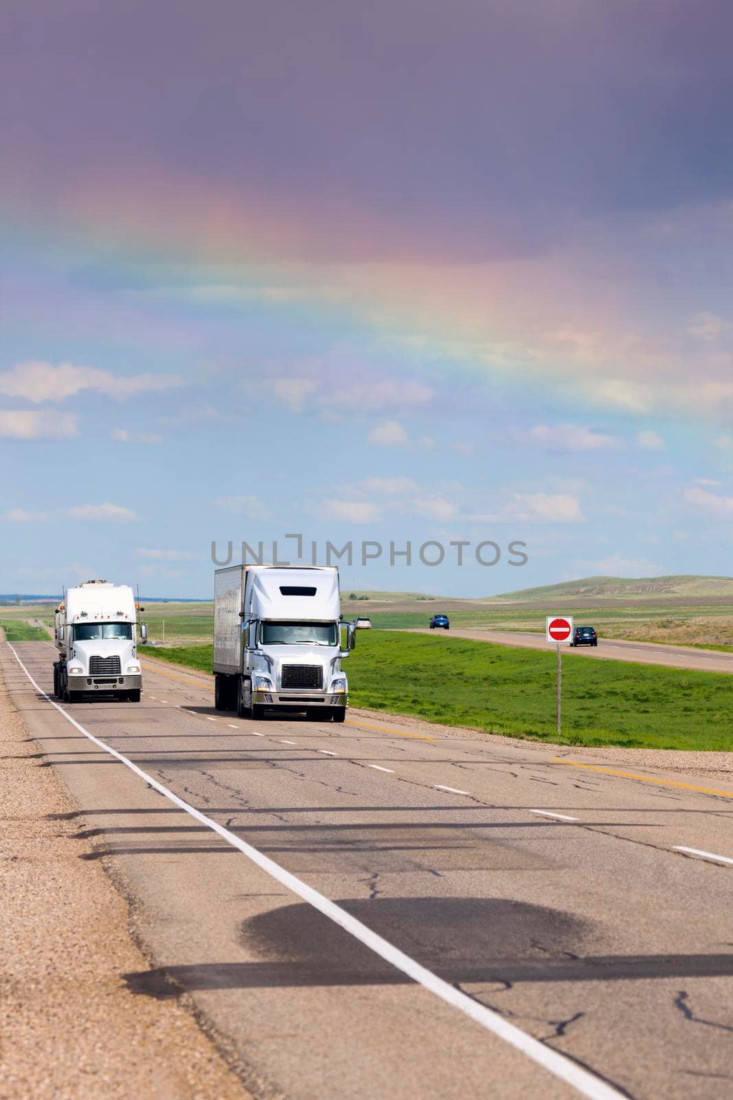 Rainbow over the highway in Saskatchewan. Saskatchewan, Canada.