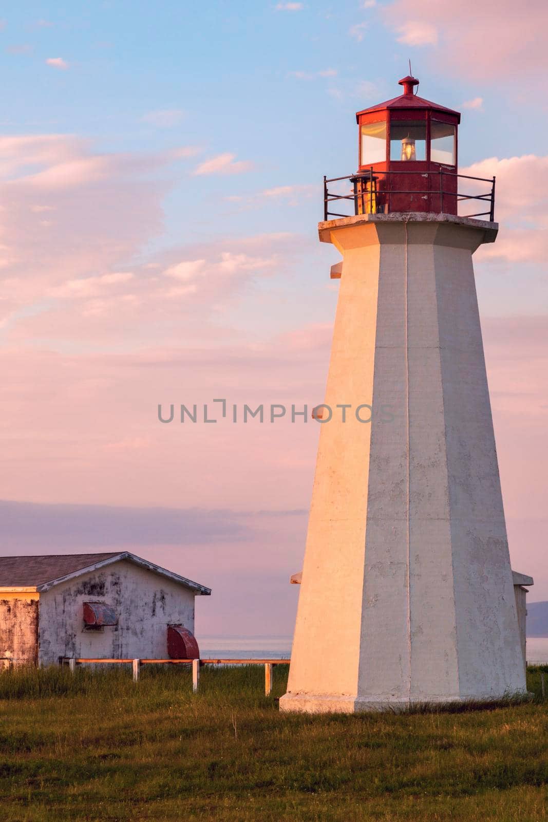 Enragee Point Lighthouse in Nova Scotia seen at sunset. Nova Scotia, Canada.