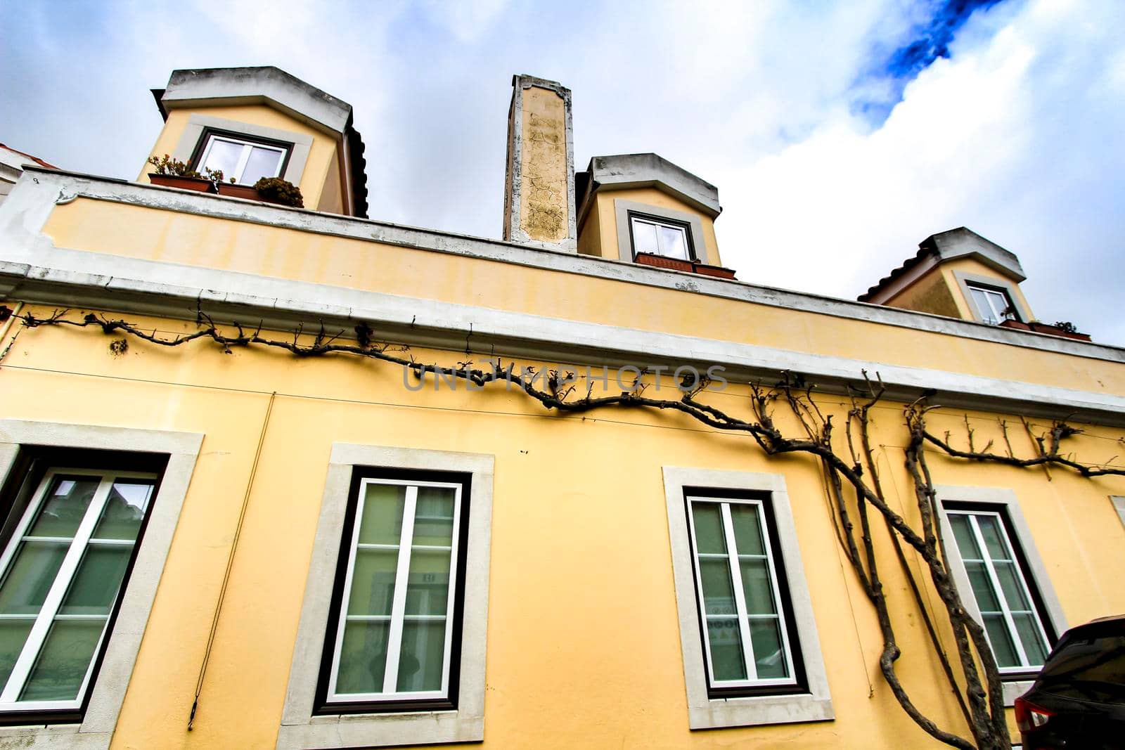 Old colorful and beautiful facades with vintage streetlight in Lisbon streets in Spring.