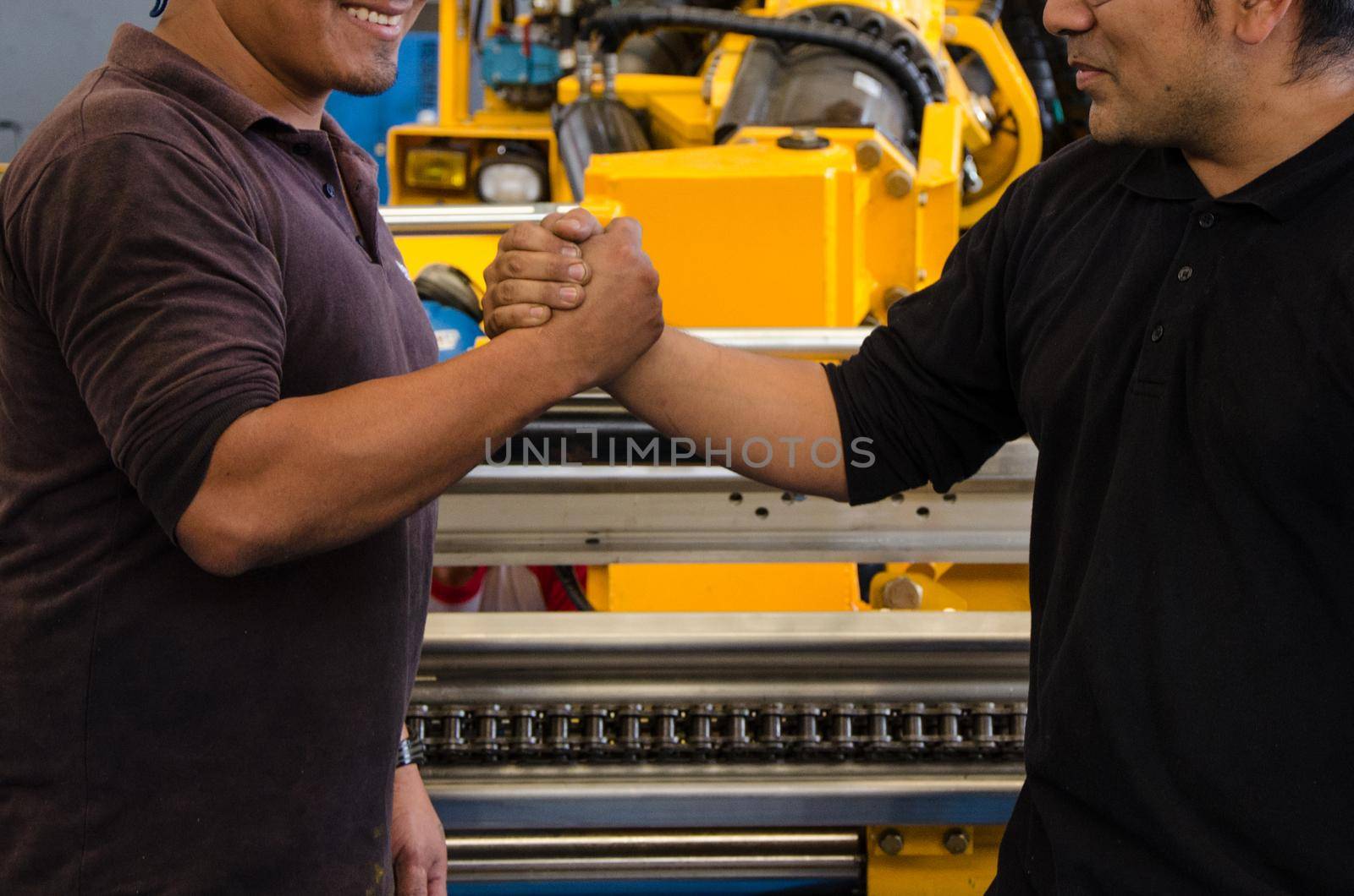 Handshake of construction worker at the construction site. by Peruphotoart